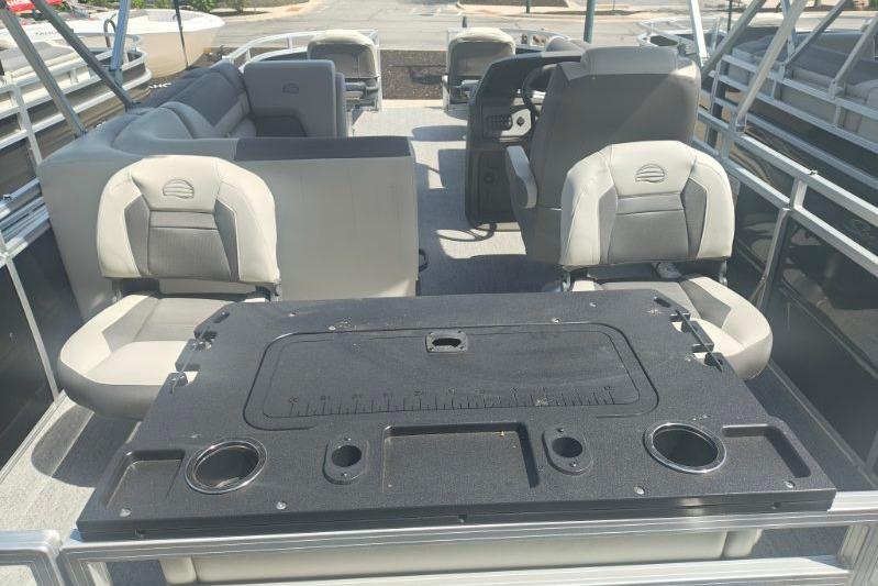 2026 Sun Tracker Fishin' Barge 20 DLX interior with seating and fishing station.