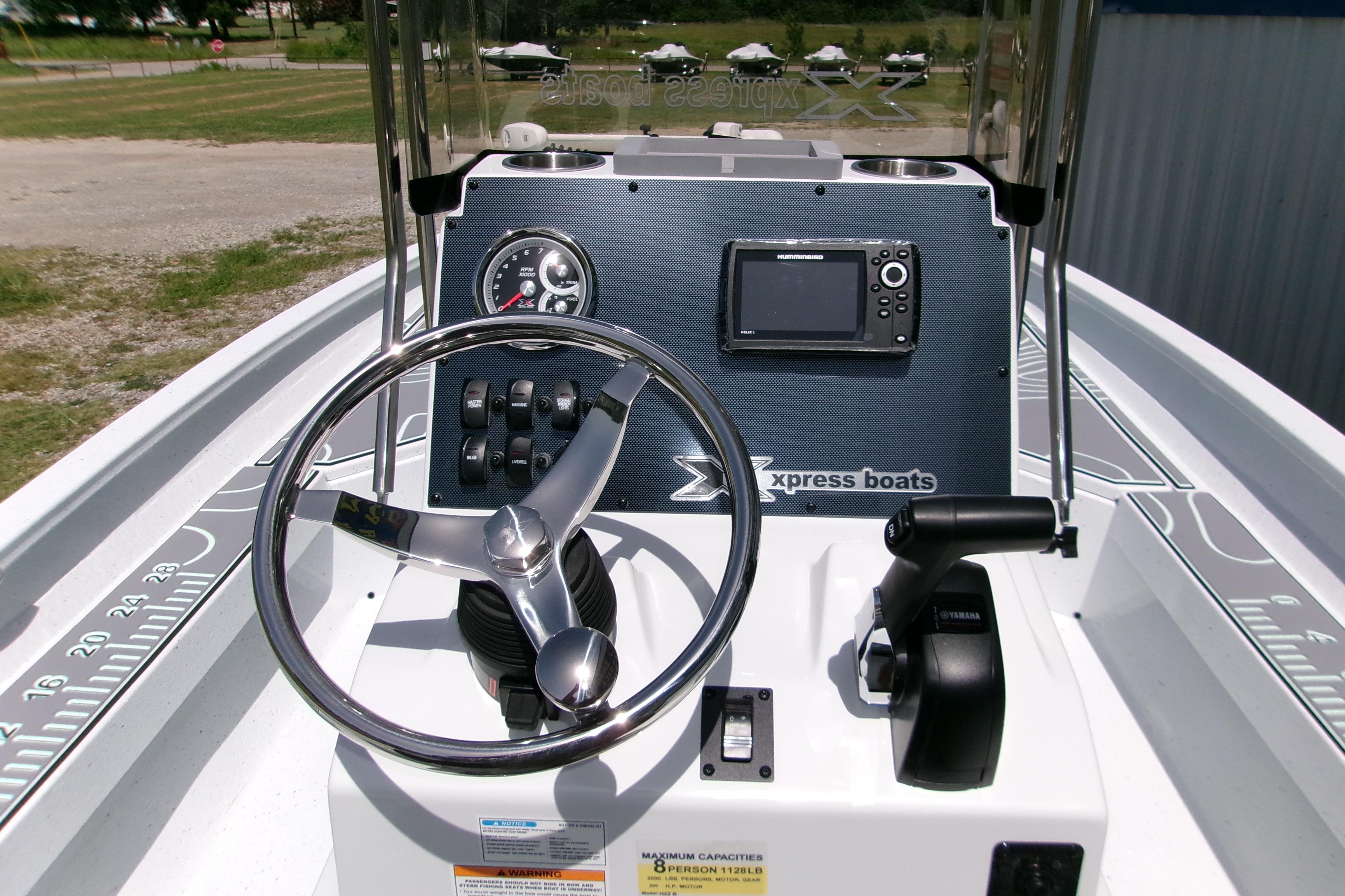 Steering console of 2027 Xpress H22B Bay boat with navigation controls.
