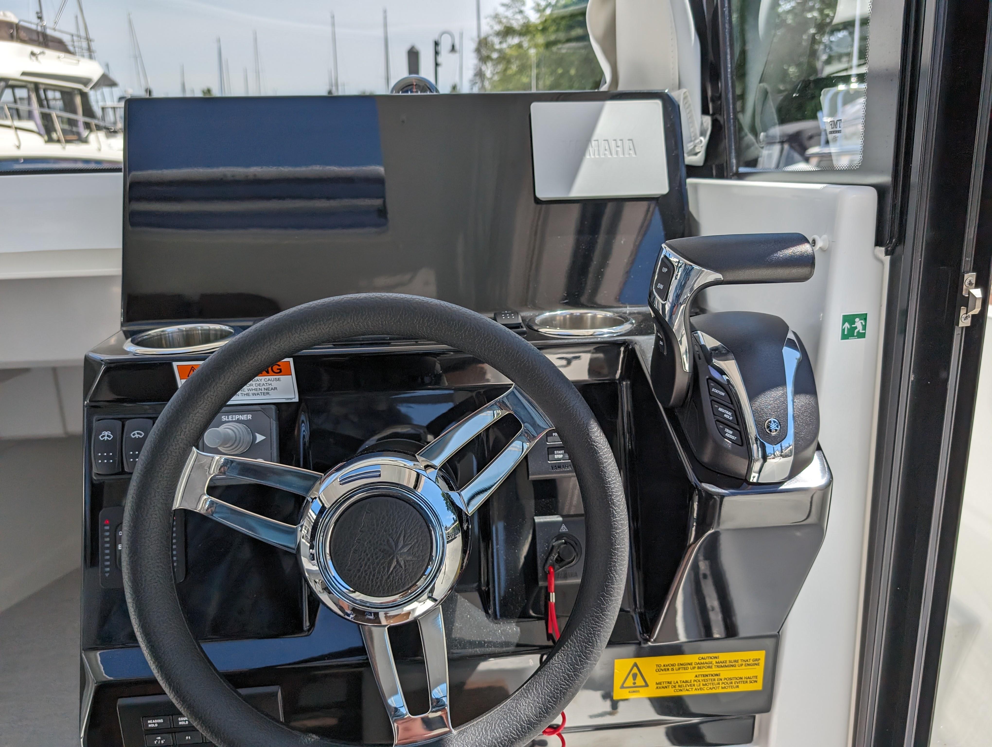 Steering console of 2024 Jeanneau NC Sport 795 Series 2 boat, featuring modern controls.