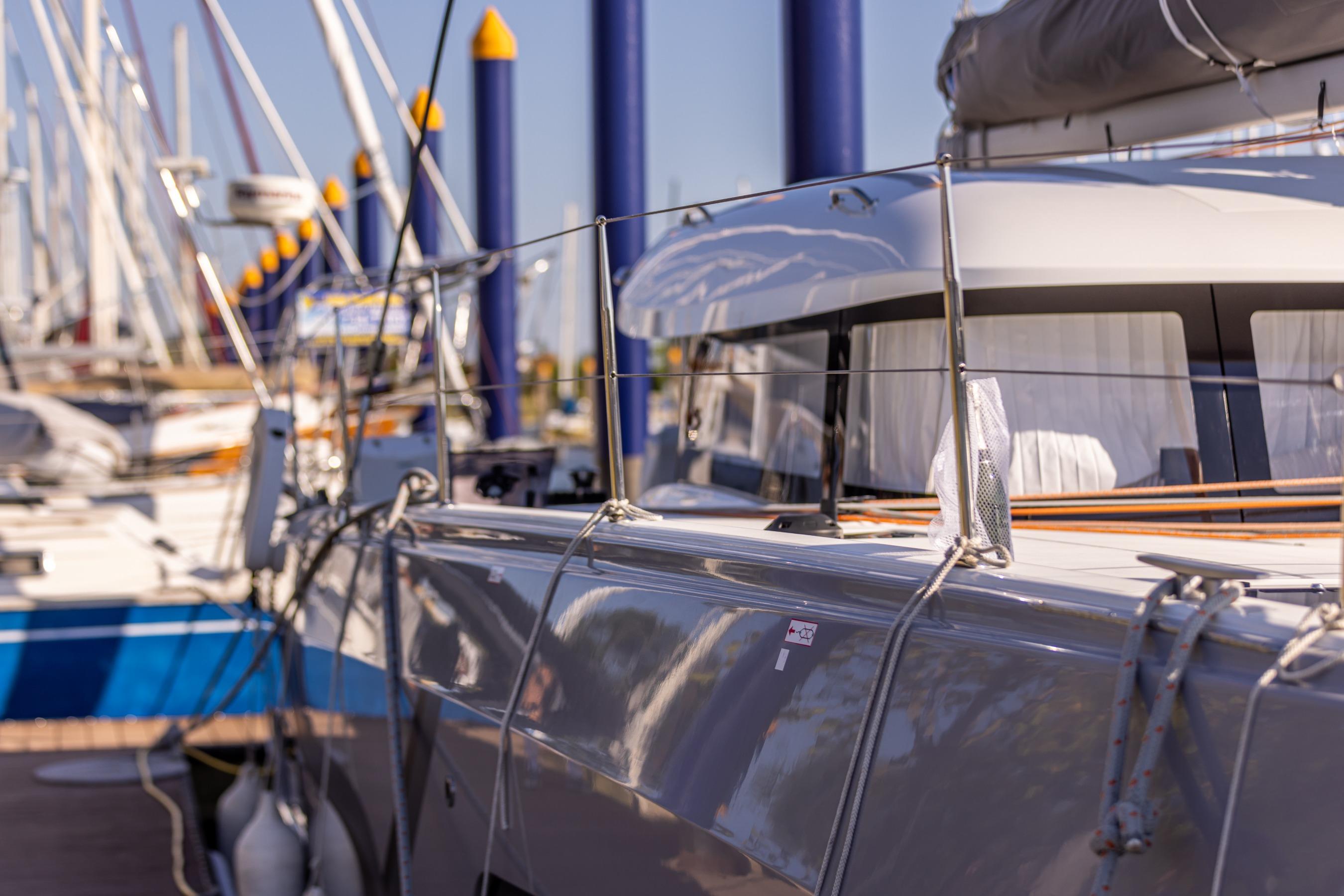 2022 Excess 11 yacht docked at marina, surrounded by other sailboats.