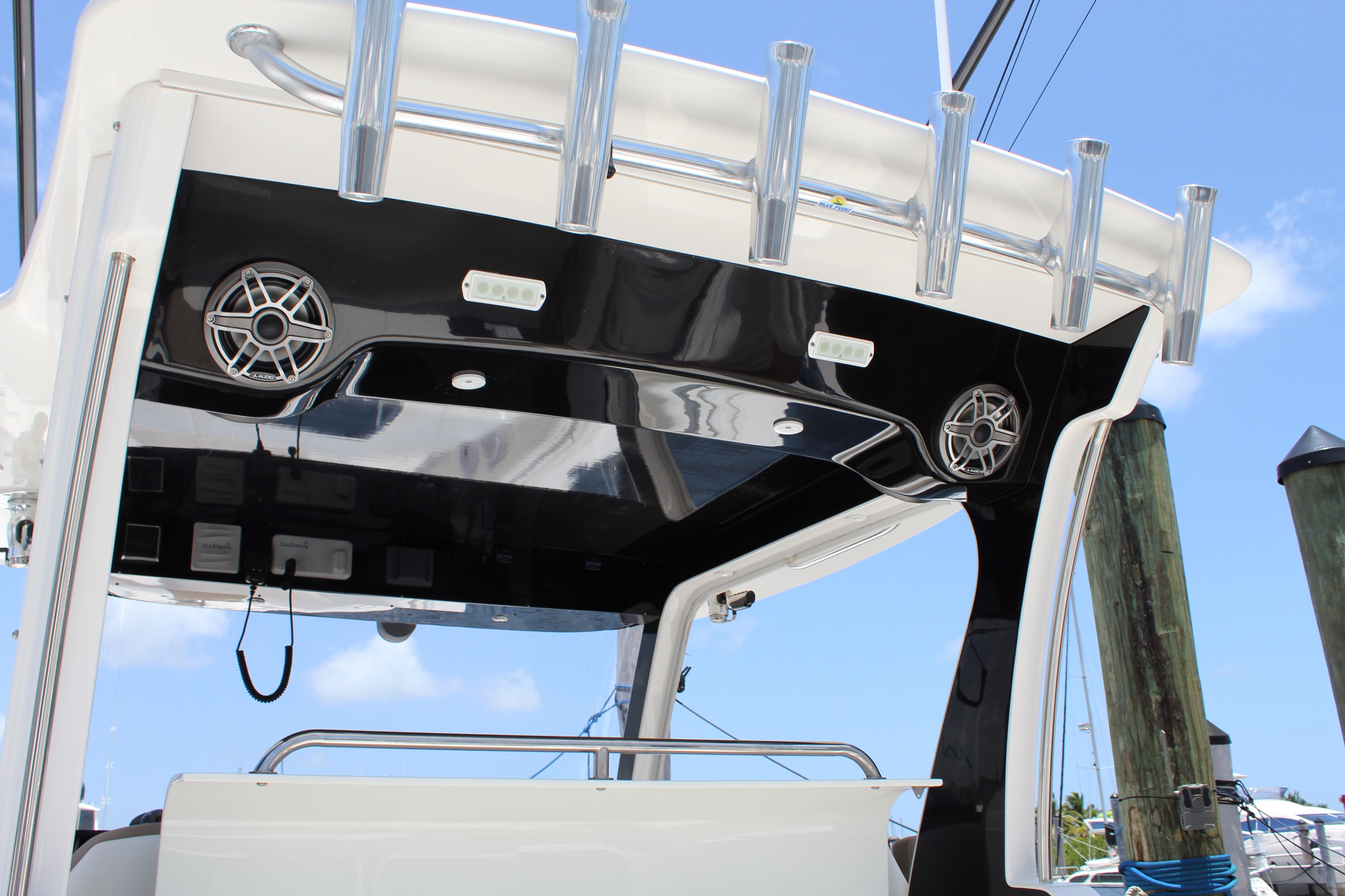 2016 Edgewater 370CC boat with sleek black and white design, featuring speakers and rod holders.
