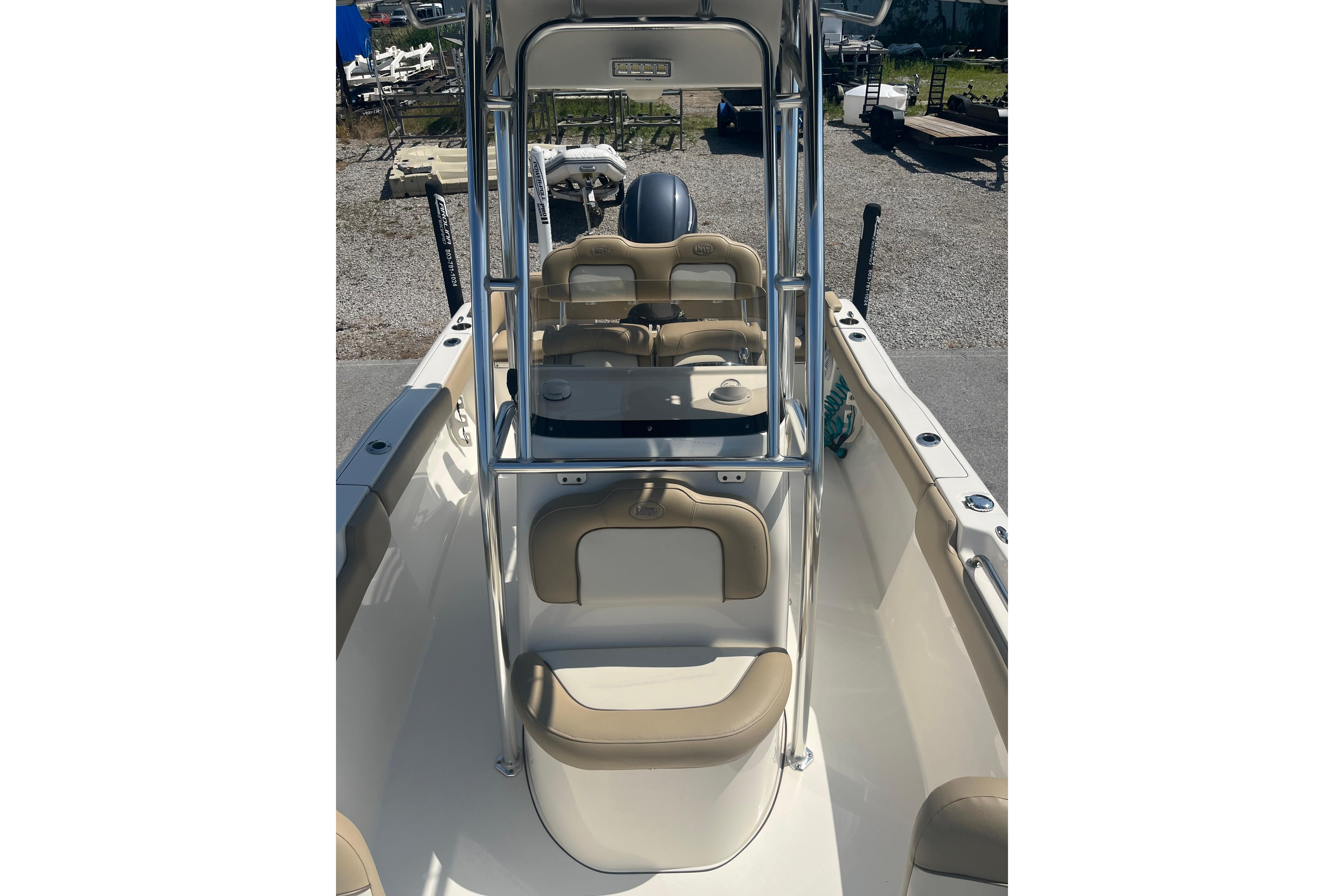 2017 Key West 203 FS boat interior with beige seating and center console.