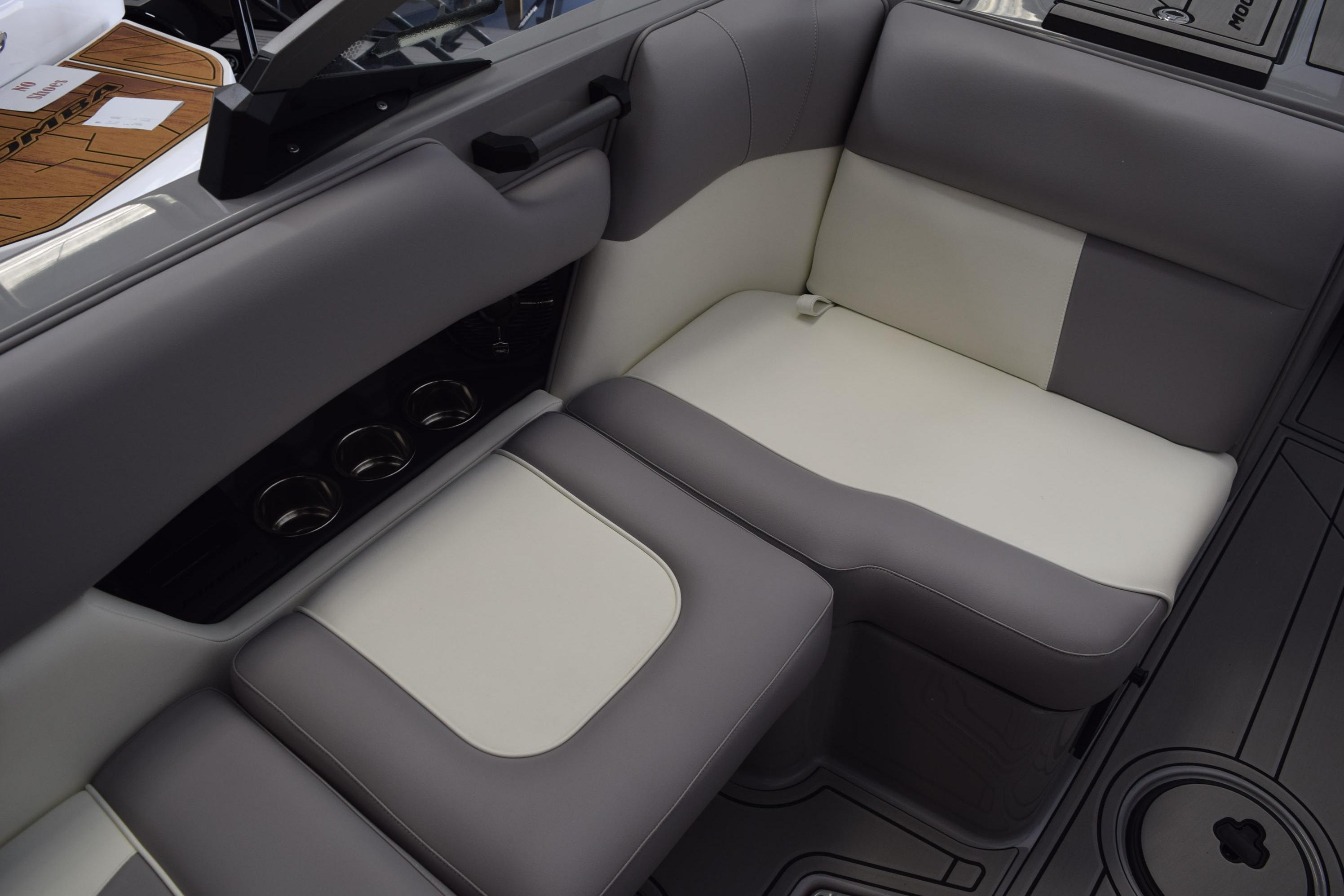 2026 Moomba Craz boat interior with gray and white seating and cup holders.
