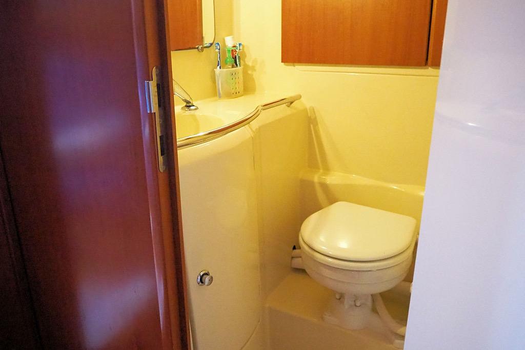 Compact bathroom in 2004 Dufour 40 Performance yacht, featuring toilet and sink.