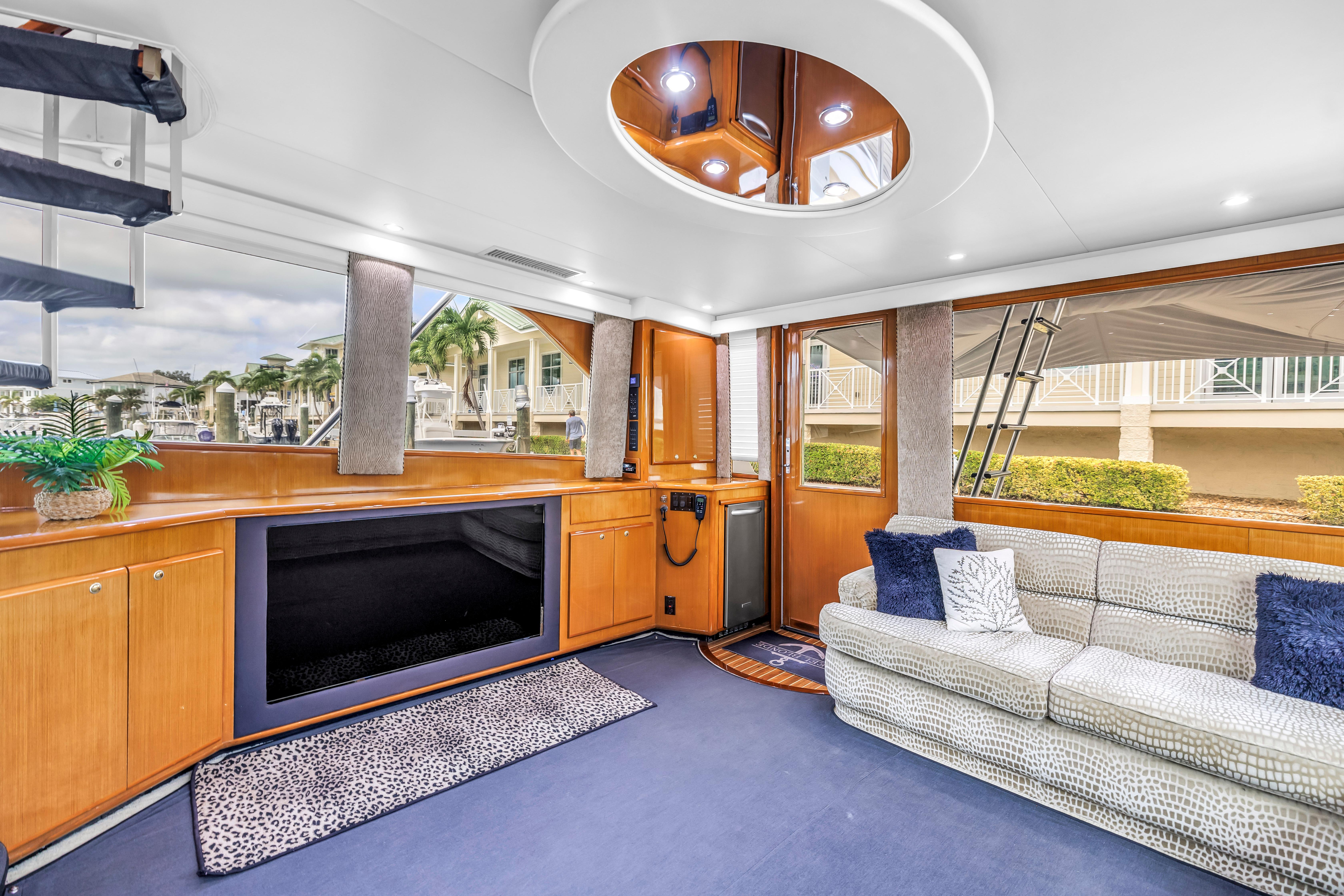 Luxurious interior of 1999 Viking 72 Enclosed Bridge yacht with plush seating and modern decor.