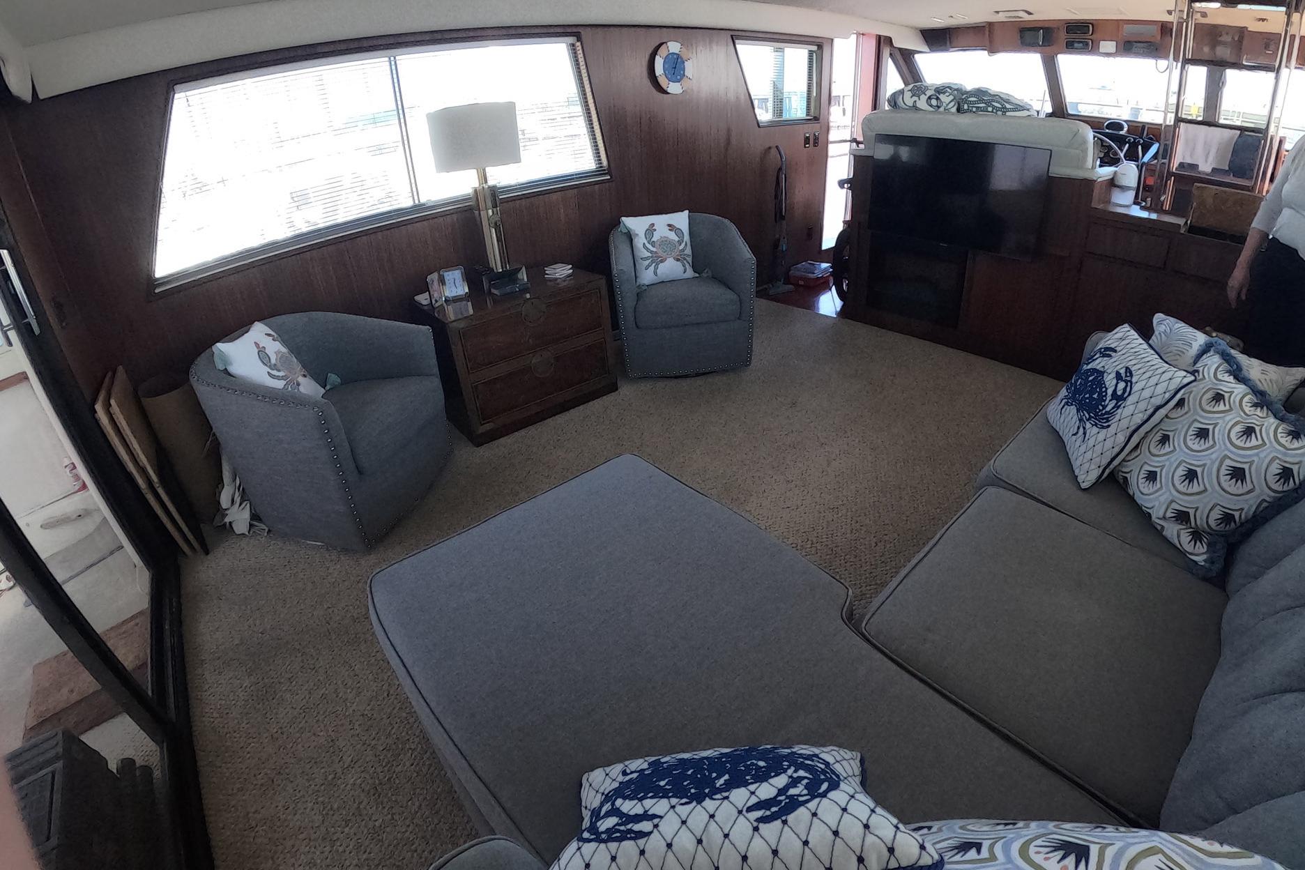 Interior of 1987 Hatteras 54 Motor Yacht with cozy seating and nautical decor.