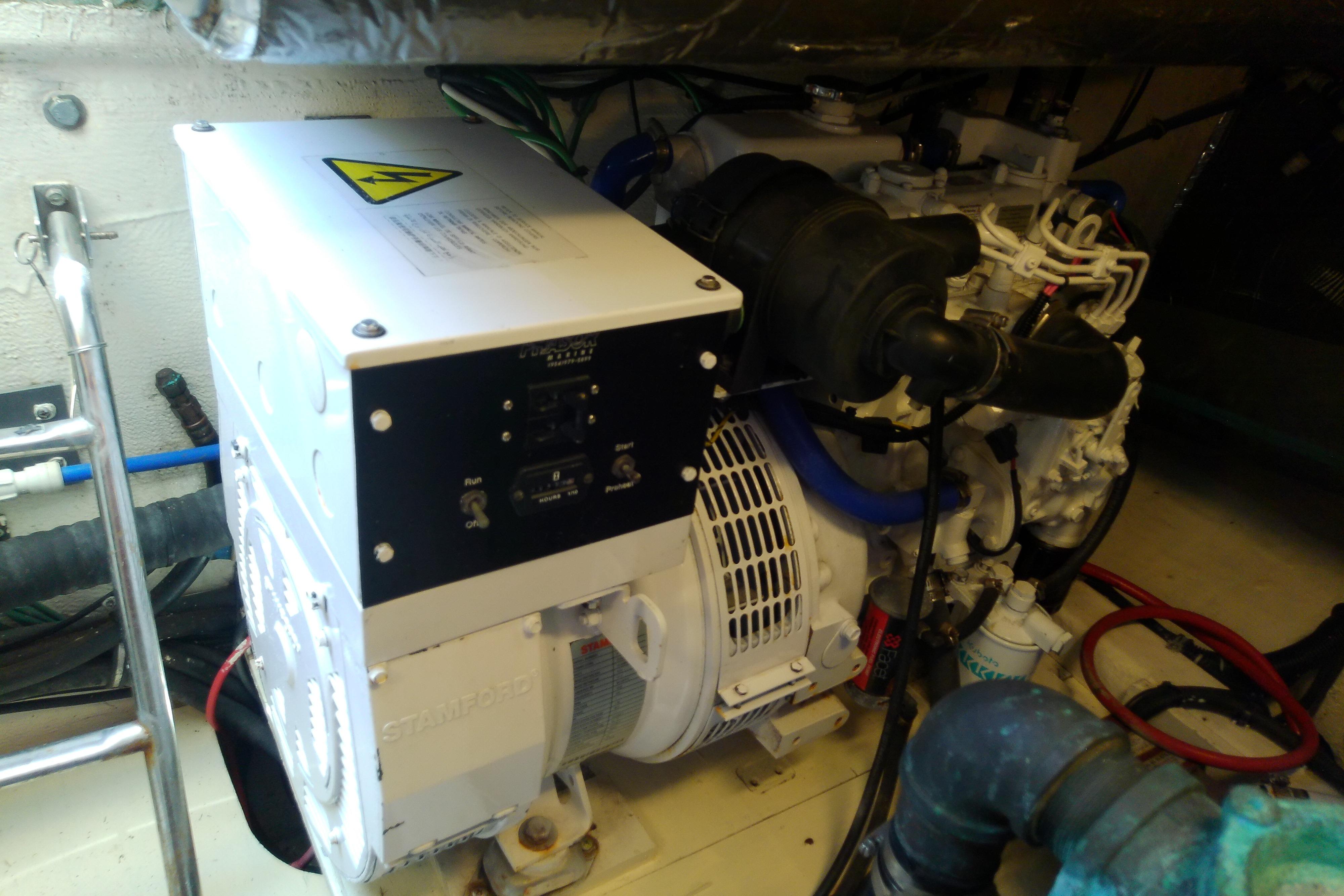 Engine room of 2000 Tiara Yachts 4100 Open, featuring generator and wiring.