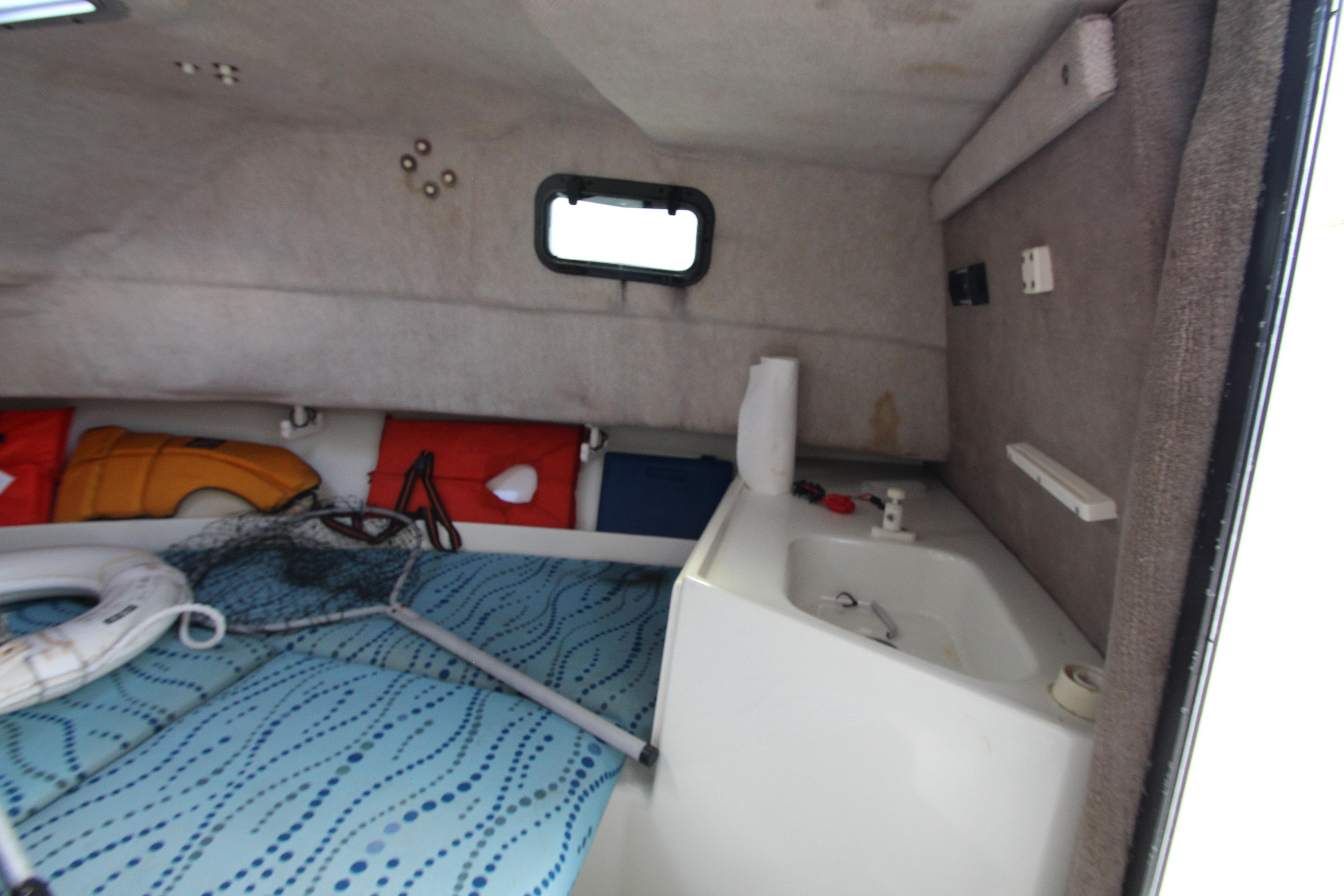 Interior cabin of 2002 Hydra-Sports 230 WA boat with sink and safety equipment.