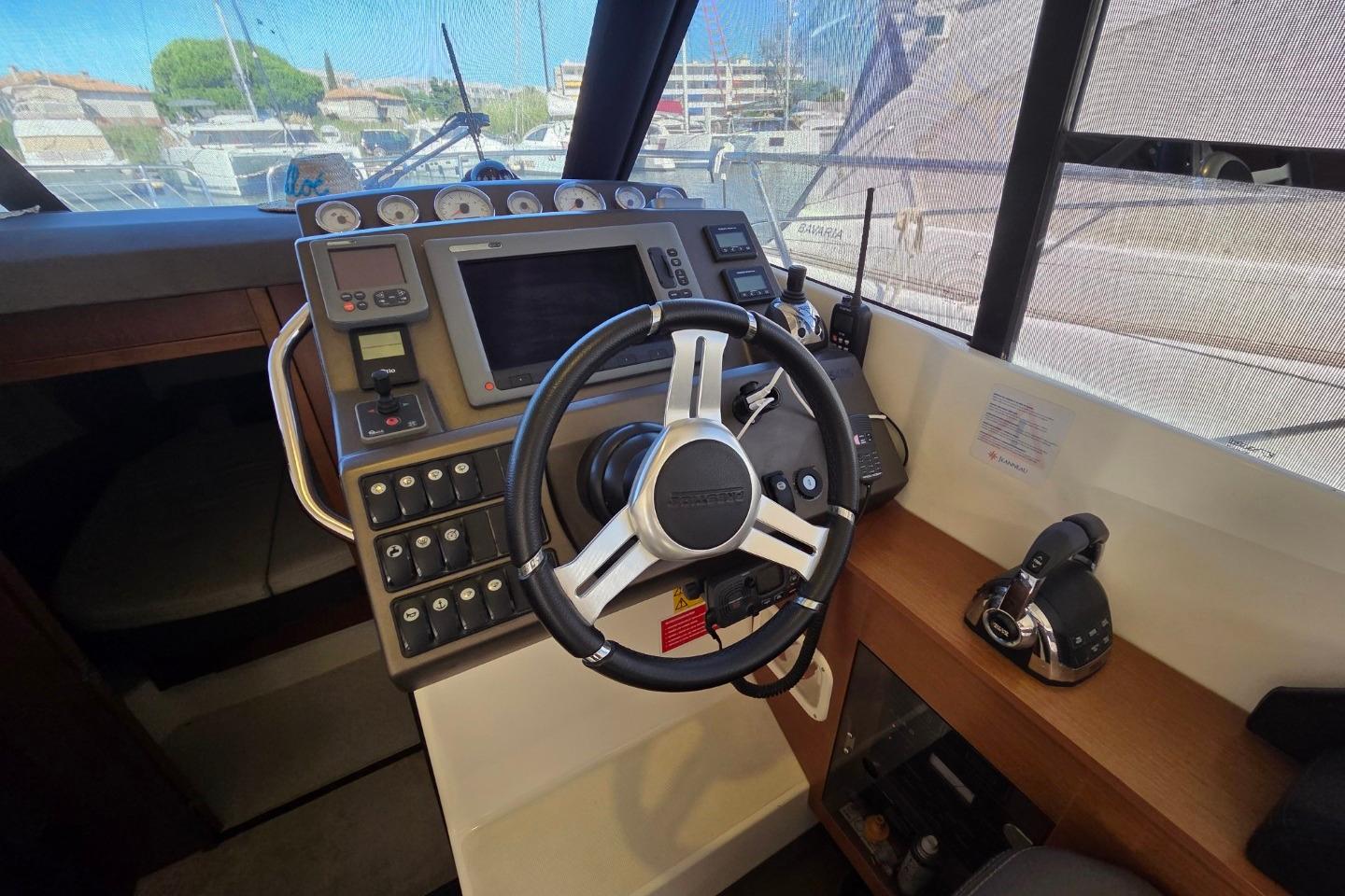 Cockpit of 2011 Jeanneau PRESTIGE 350 Flybridge with steering wheel and control panel.