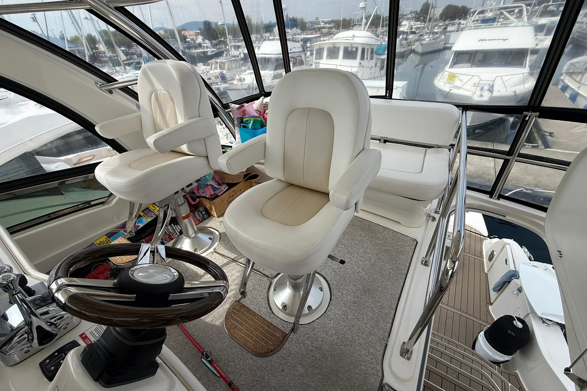 Interior of 2010 Sea Ray 520 Sedan Bridge yacht with helm and seating area.