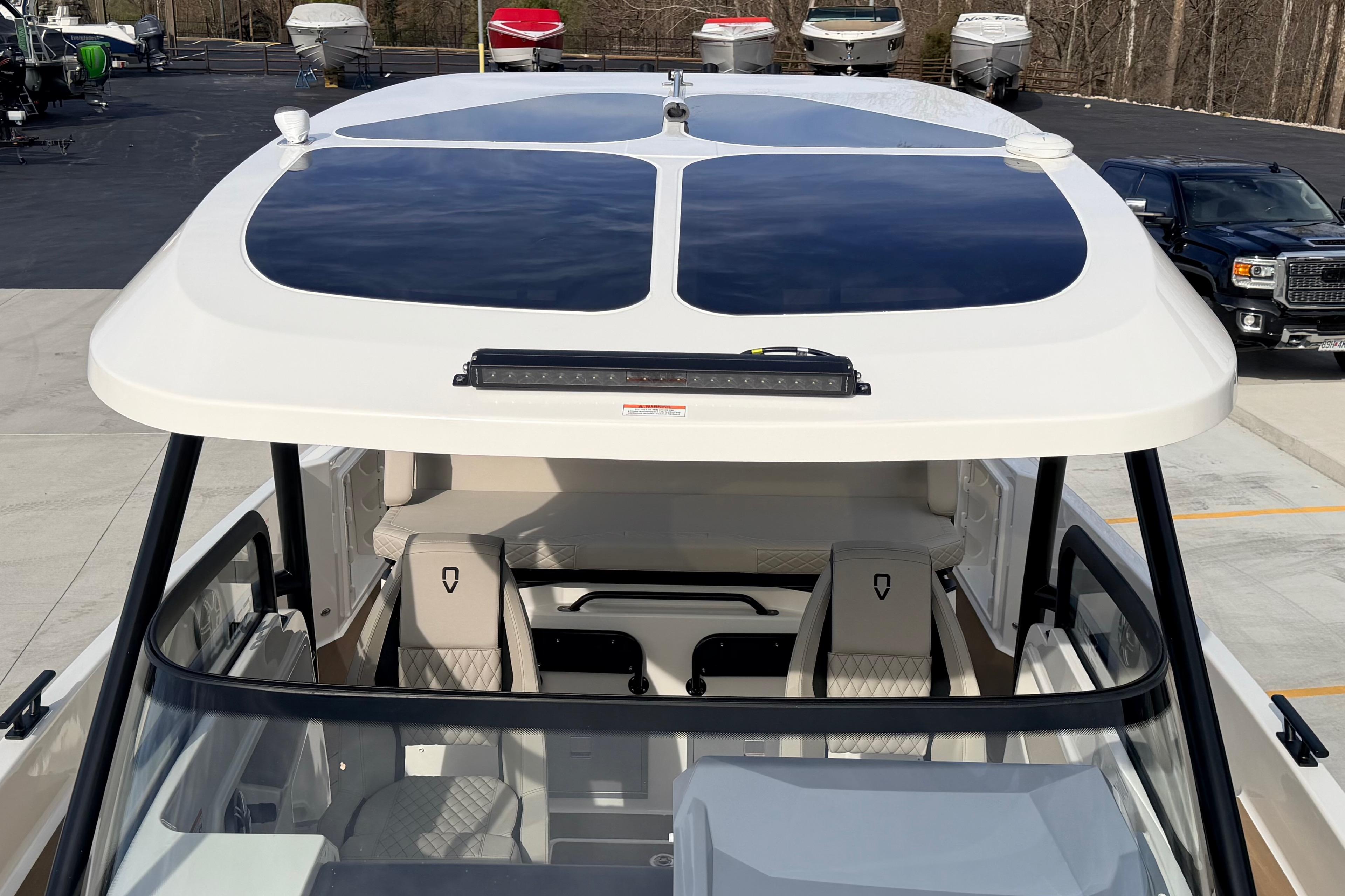 Navan S30 2026 boat with sleek design and modern seating, parked outdoors.