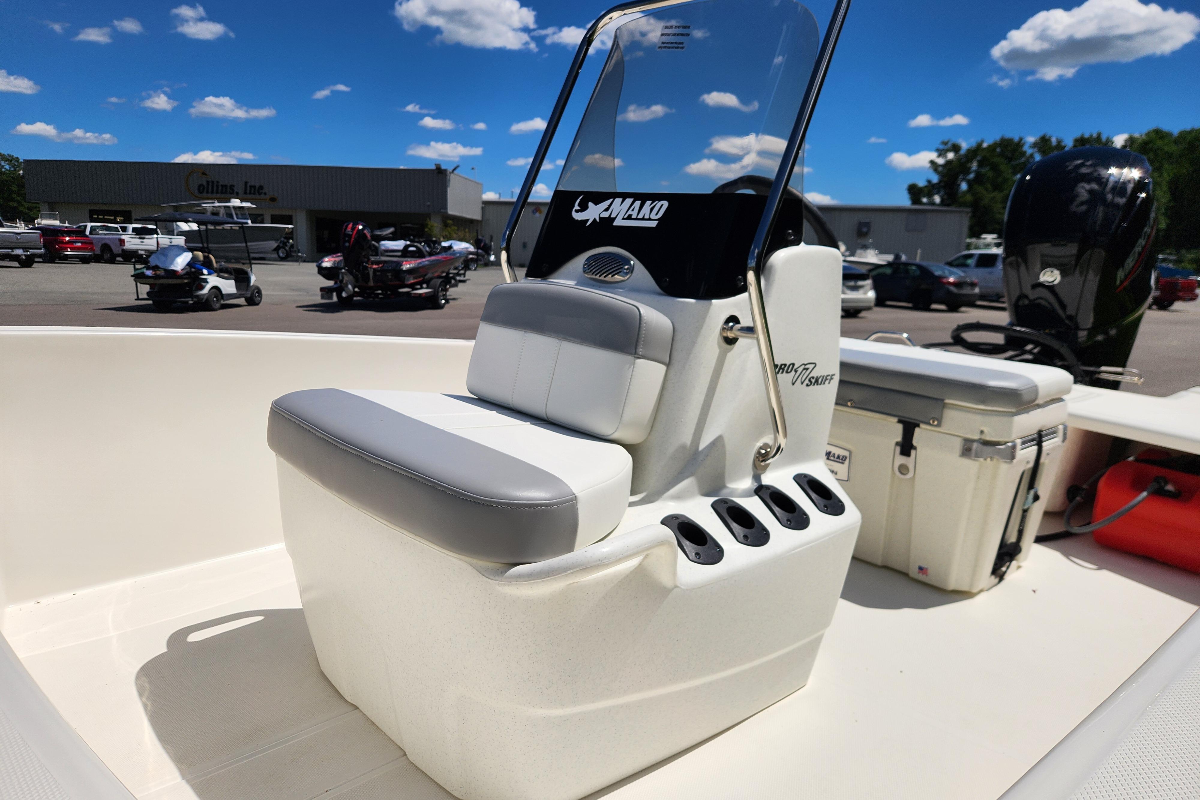 2026 Mako Pro Skiff 17 CC boat interior with seating and console, parked outdoors.