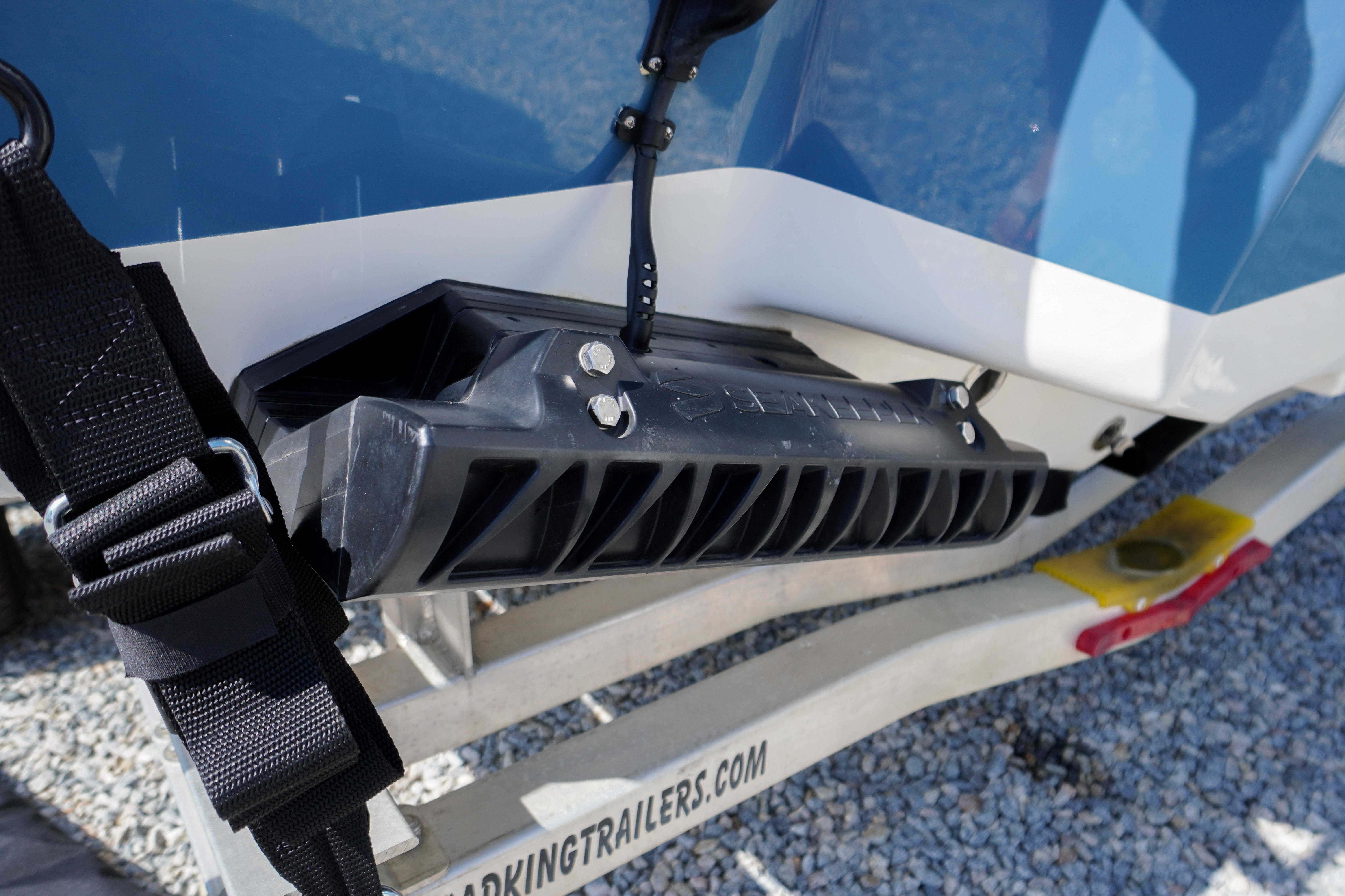 2025 Tidewater 232 SS boat on trailer, featuring secure strap and hull detail.