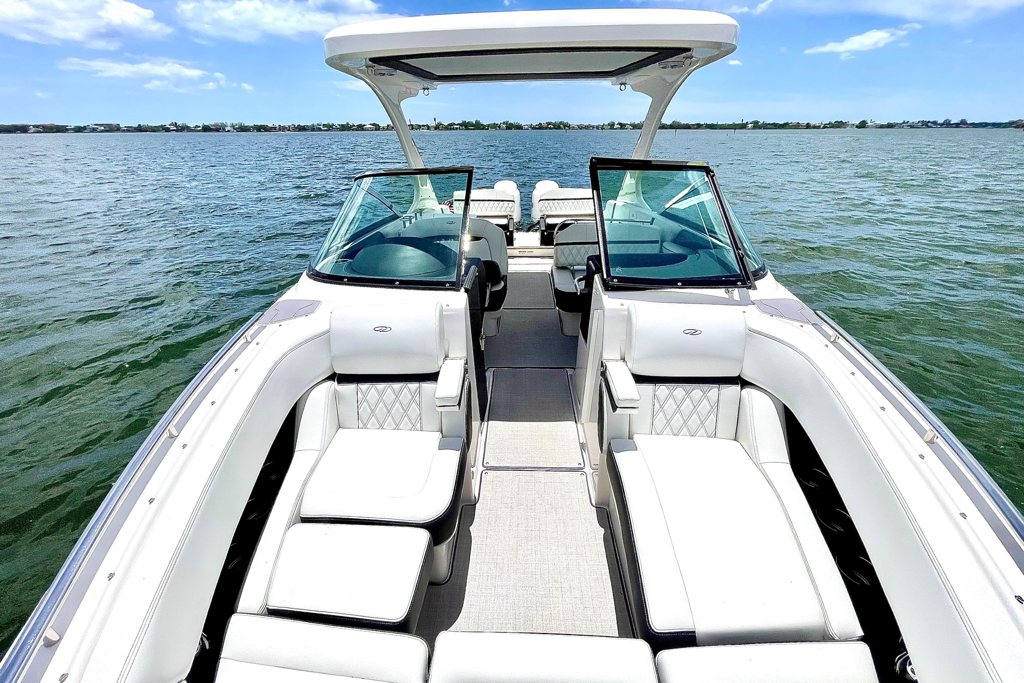 2023 Regal 29 OBX boat with luxurious seating on a serene lake.