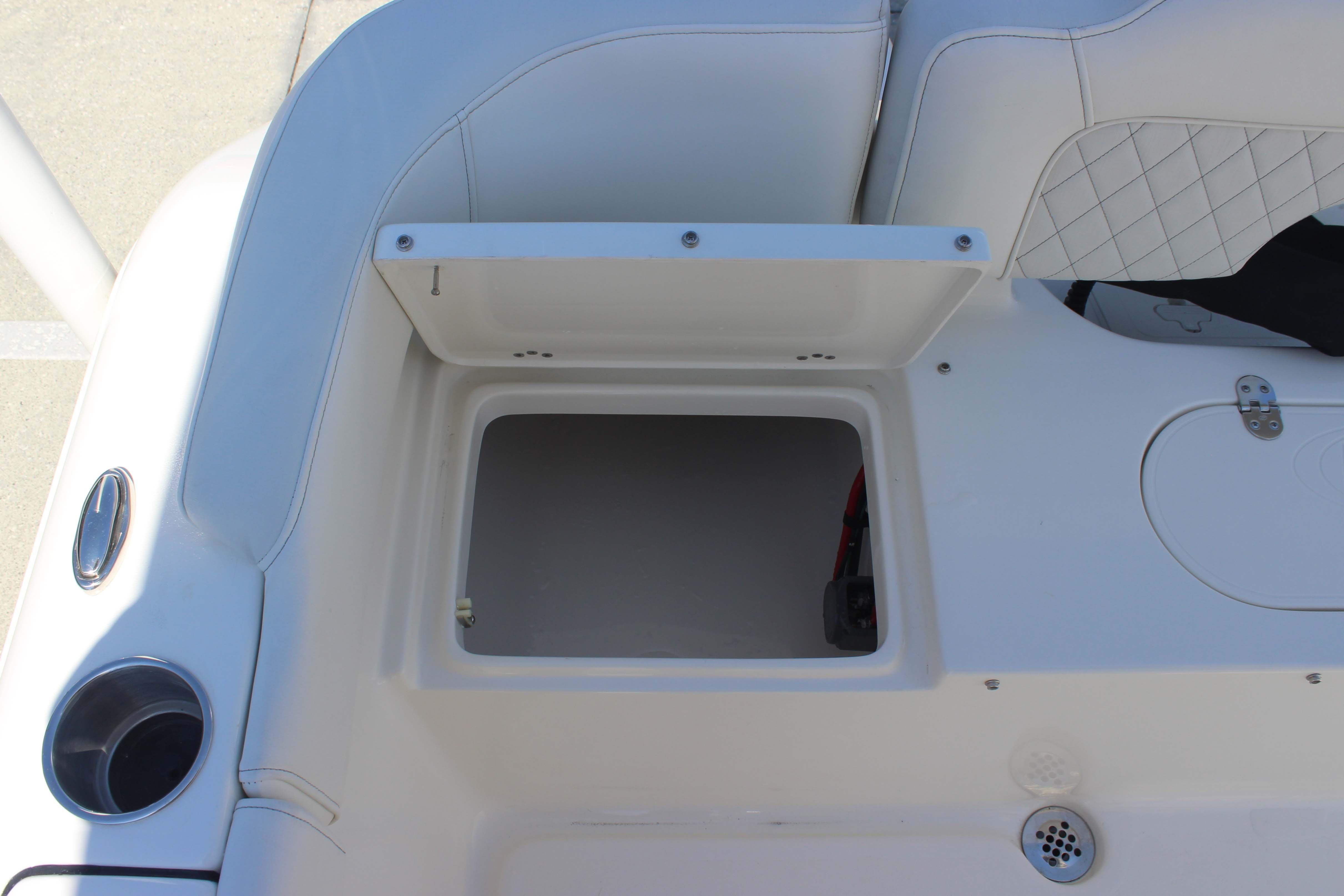 Open storage compartment on 2026 Key West 203 FS boat, featuring white cushioned seating.