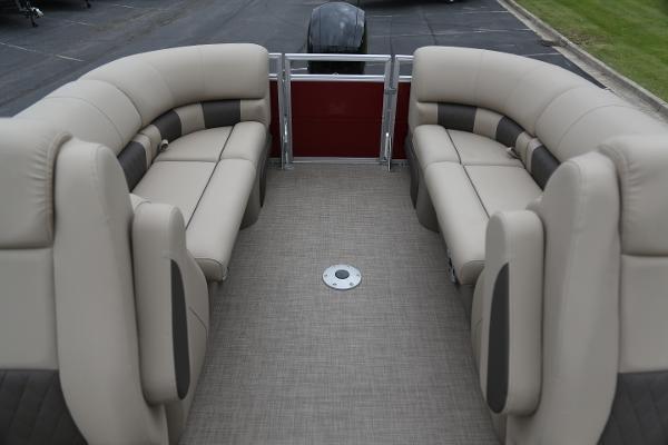2024 Sun Tracker Party Barge 24 DLX interior with beige seating and spacious layout.