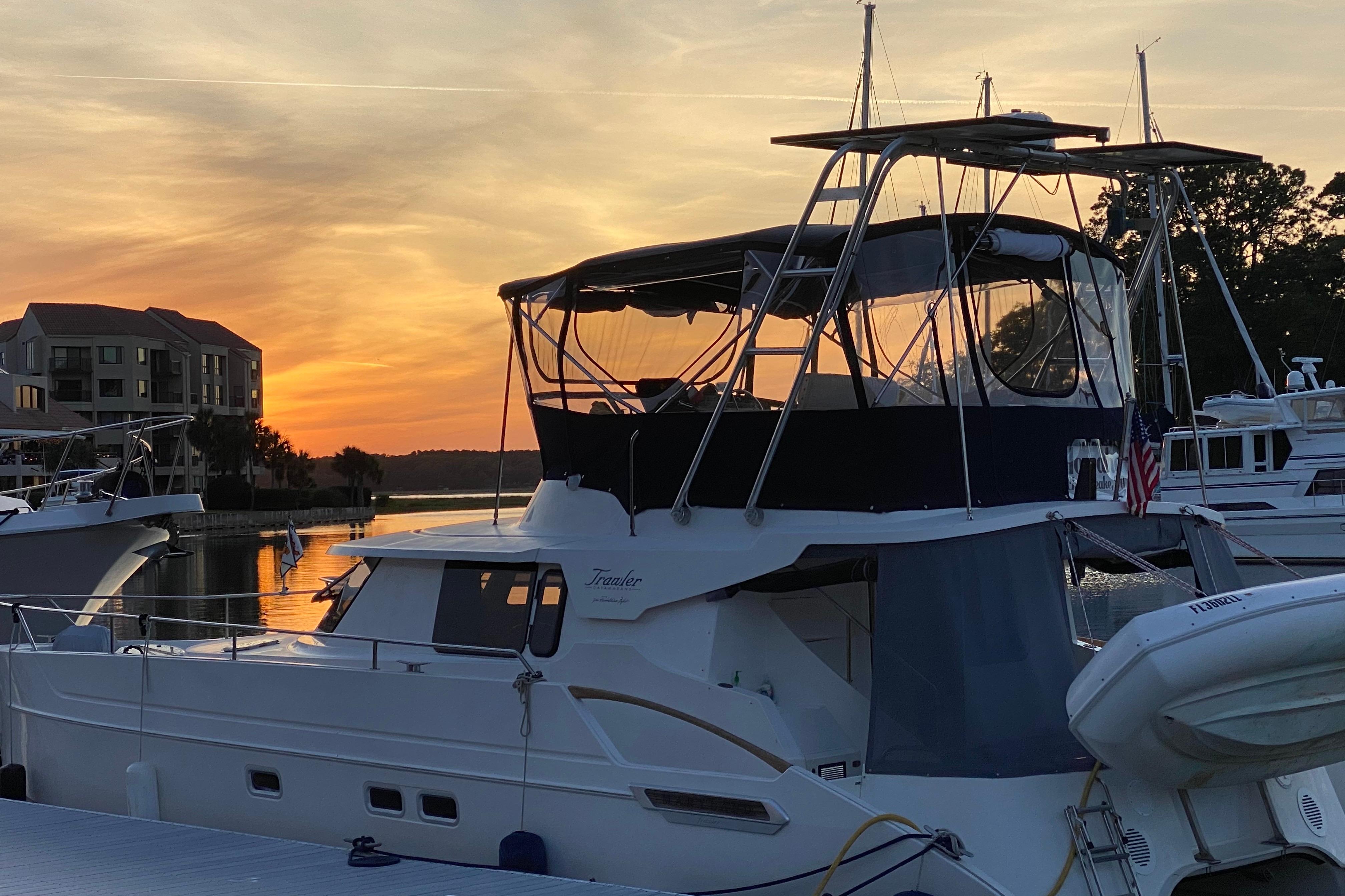 2005 Fountaine Pajot Maryland 37 yacht docked at sunset, serene waterfront view.