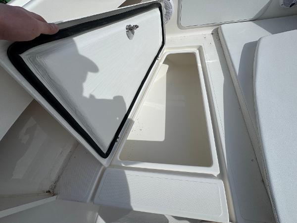 2025 NorthCoast 230 Center Console boat storage compartment open, showcasing interior space.