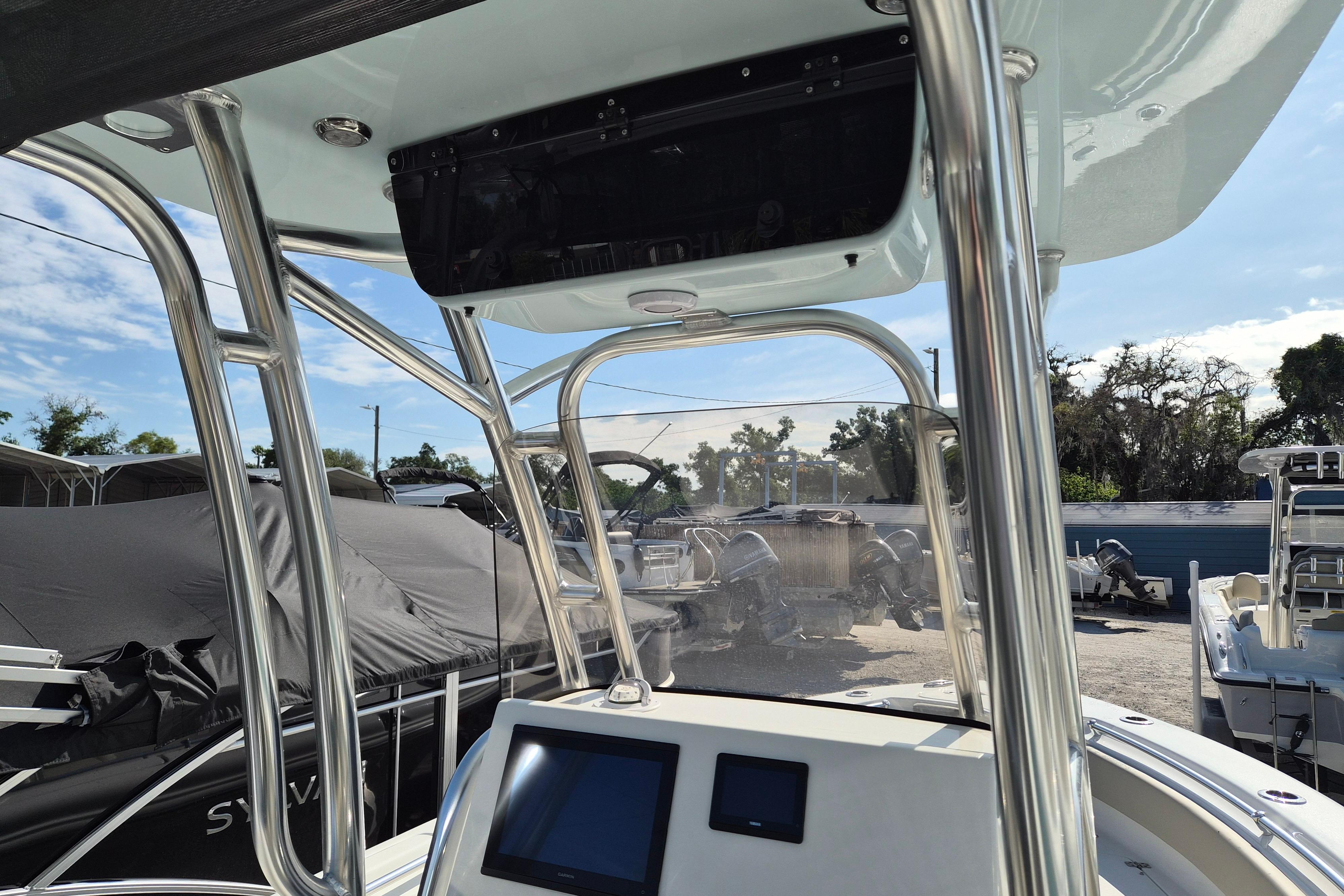 2026 Key West 239 FS boat interior with console and T-top, parked outdoors.