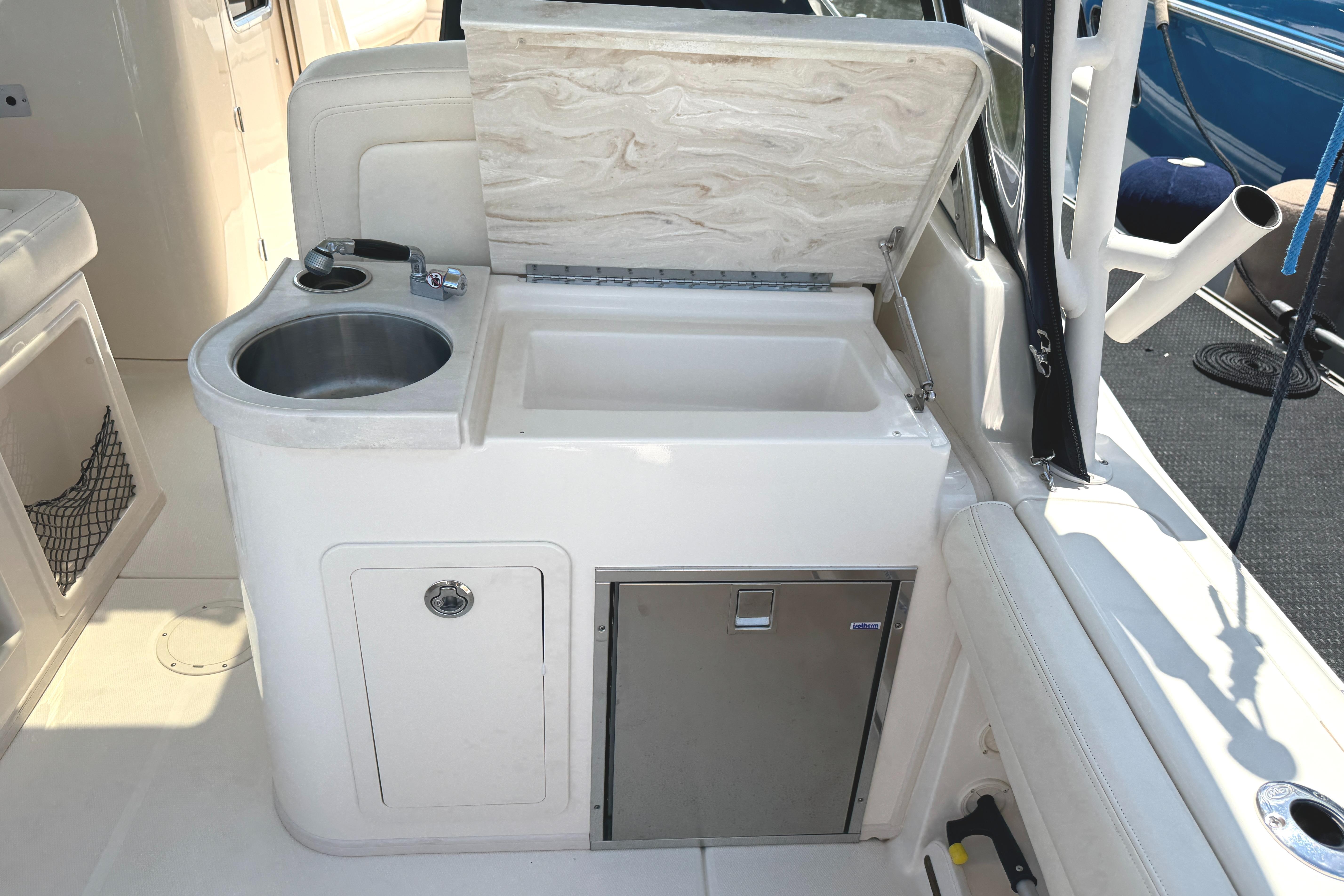 2018 Grady-White Freedom 307 boat interior with sink and storage area.