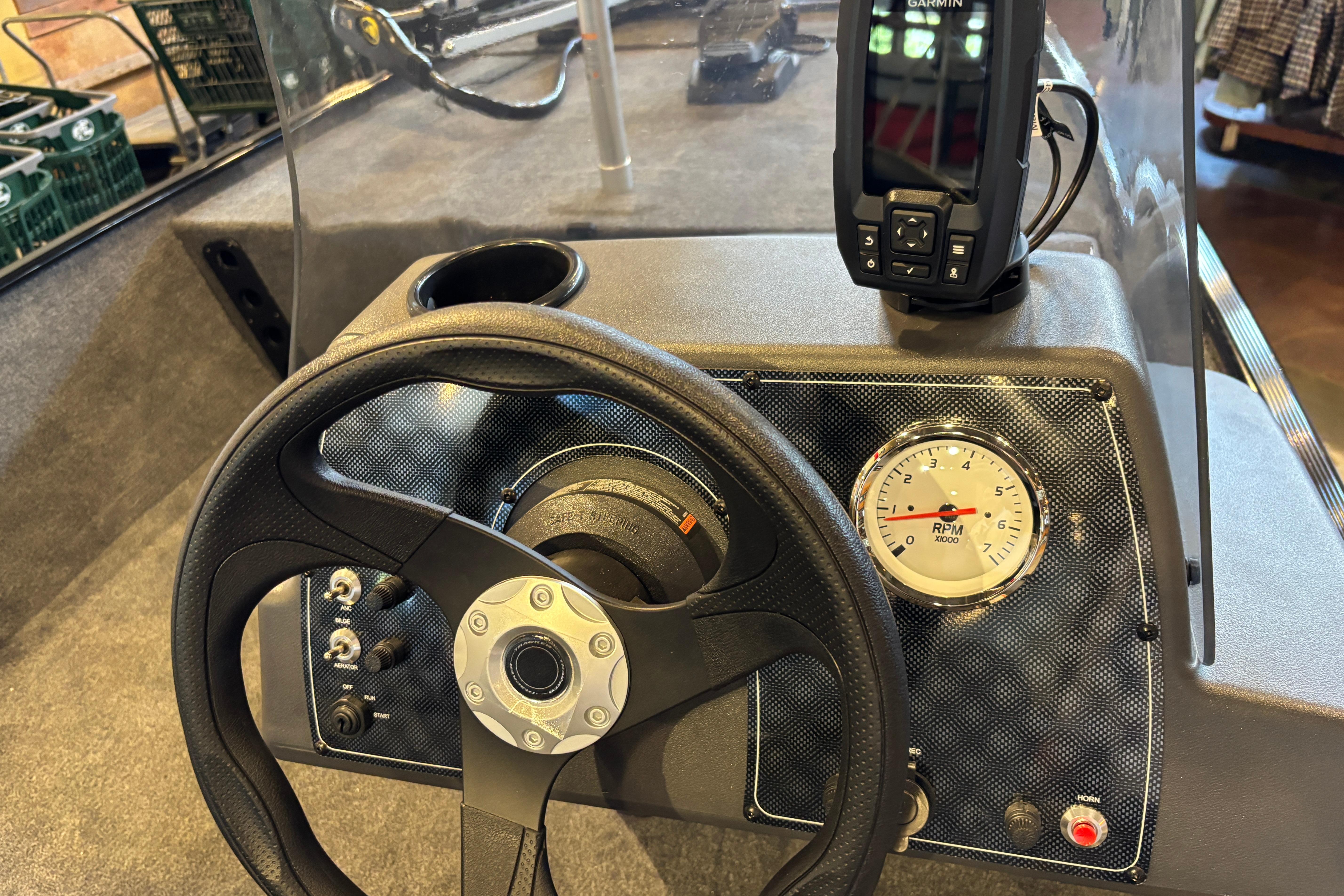 Steering console of 2026 Tracker Bass Tracker Classic XL with RPM gauge and Garmin device.