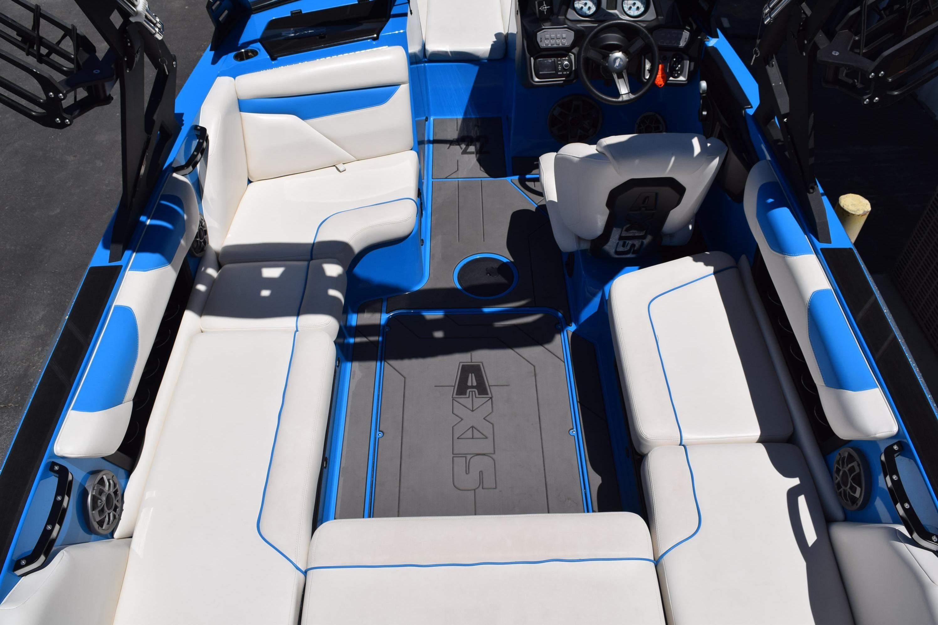 2019 Axis A22 boat interior with blue and white seating, steering wheel, and dashboard.
