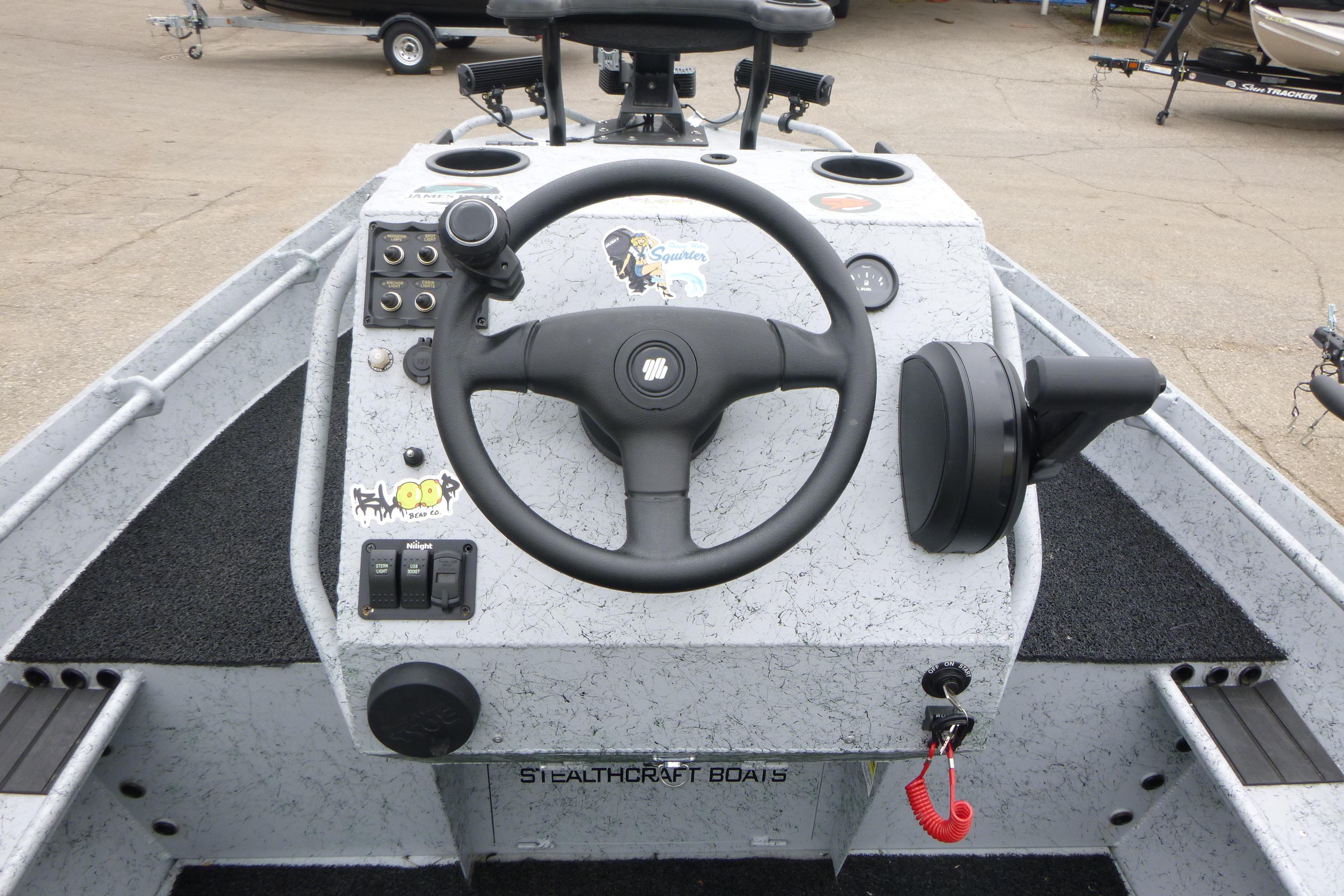 StealthCraft 16 StealthWeld 2025 boat dashboard with steering wheel and controls.