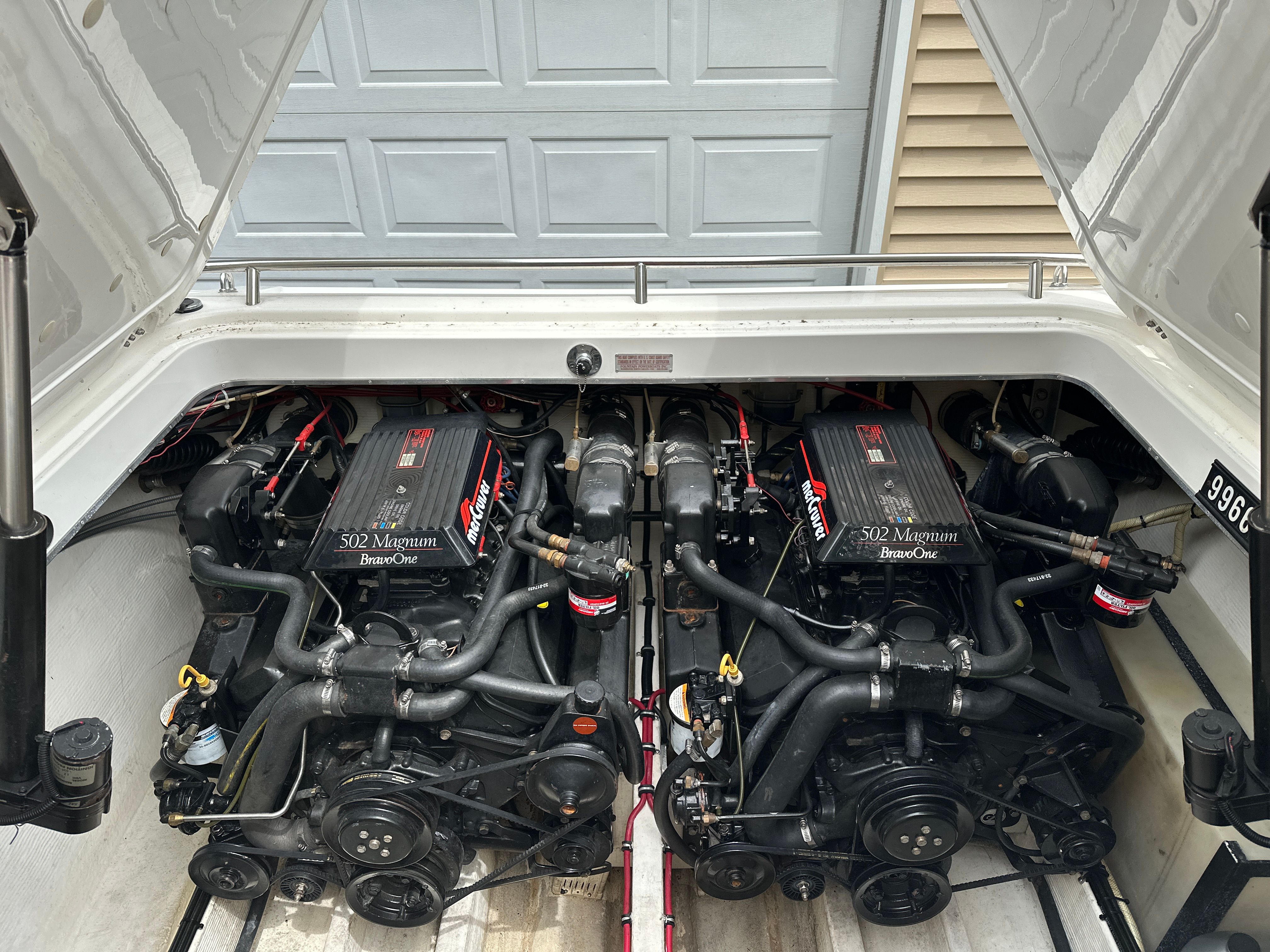 Two powerful engines inside a boat, surrounded by technical components.