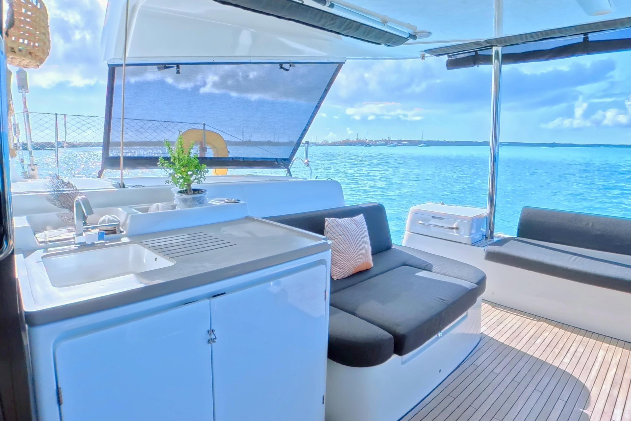Luxurious 2023 Lagoon 50 yacht interior with modern seating and ocean view.