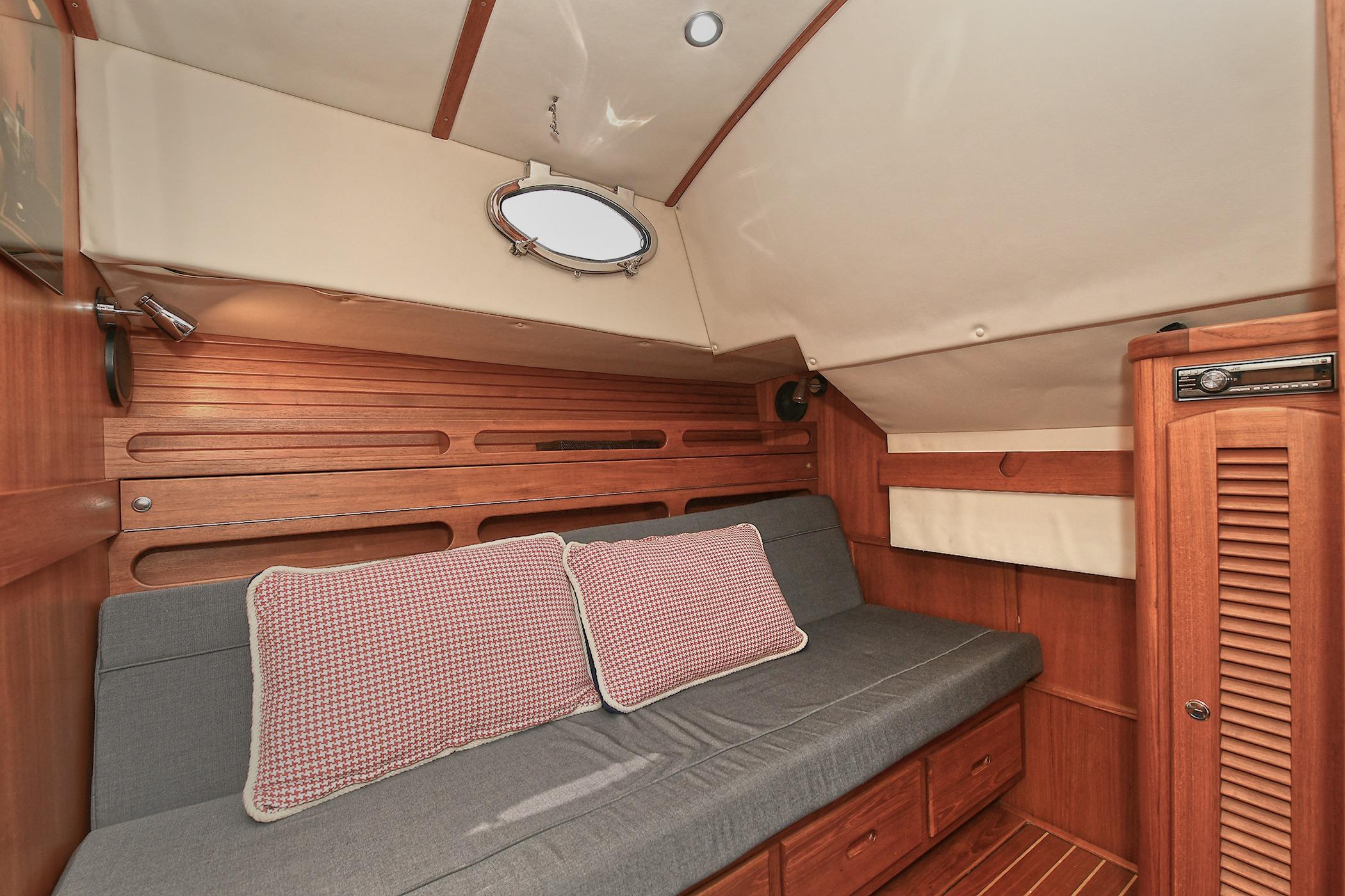 Luxurious 2005 San Juan Downeast Express cabin interior with wooden finish and cozy seating.