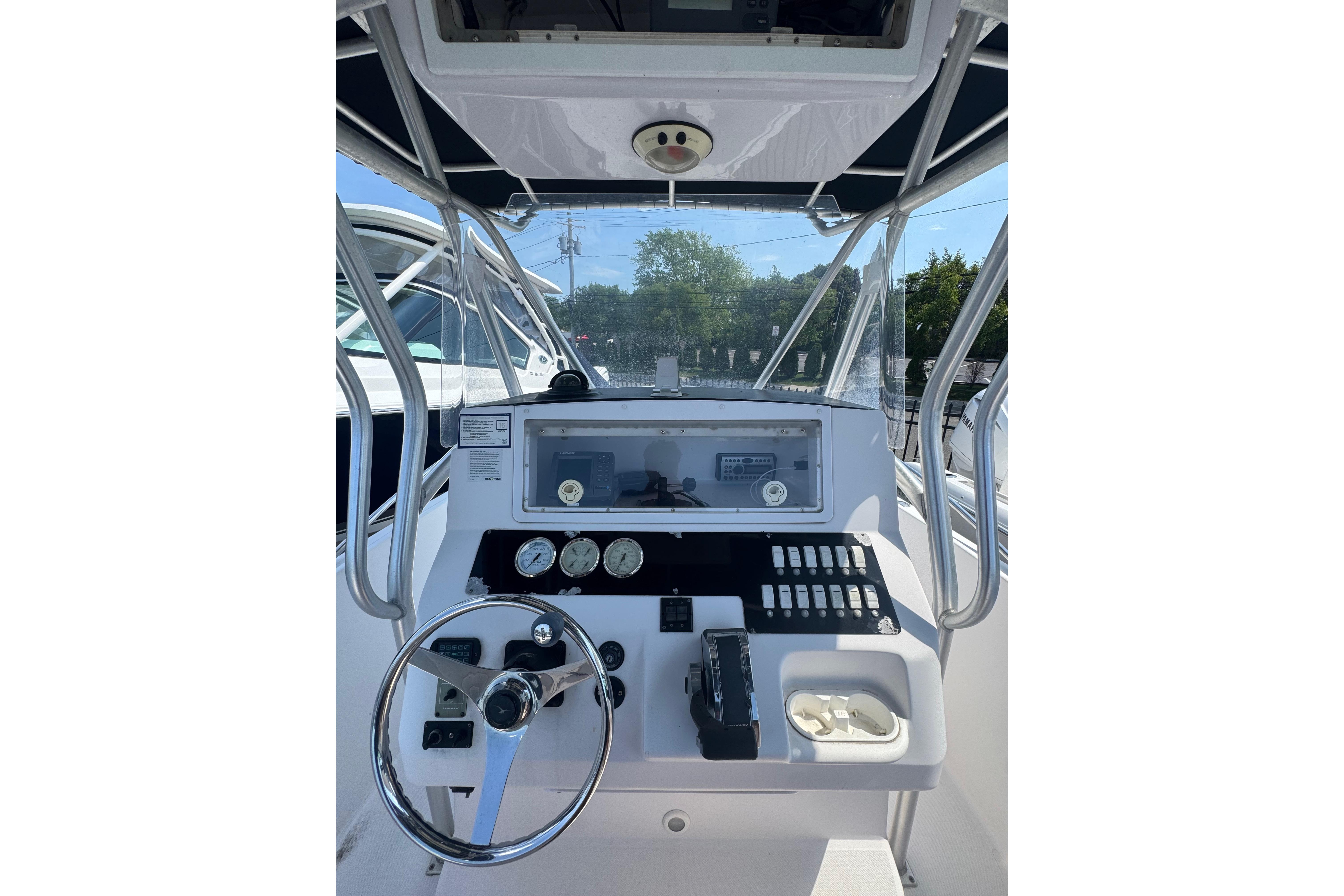 2002 Pro-Line 23 Sport boat dashboard with steering wheel and control panel.