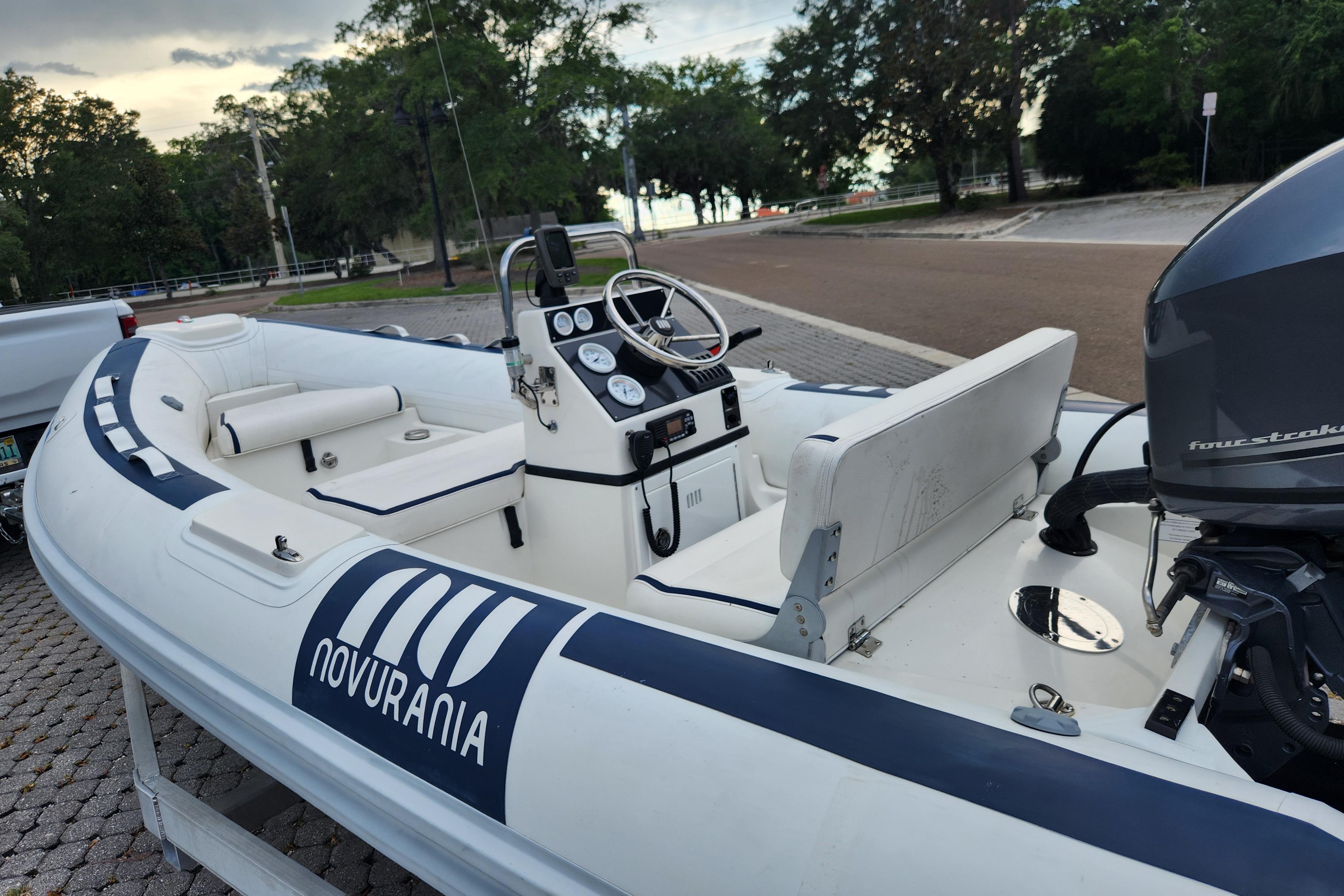 2019 Novurania DL 400 inflatable boat with outboard motor, parked on a trailer.