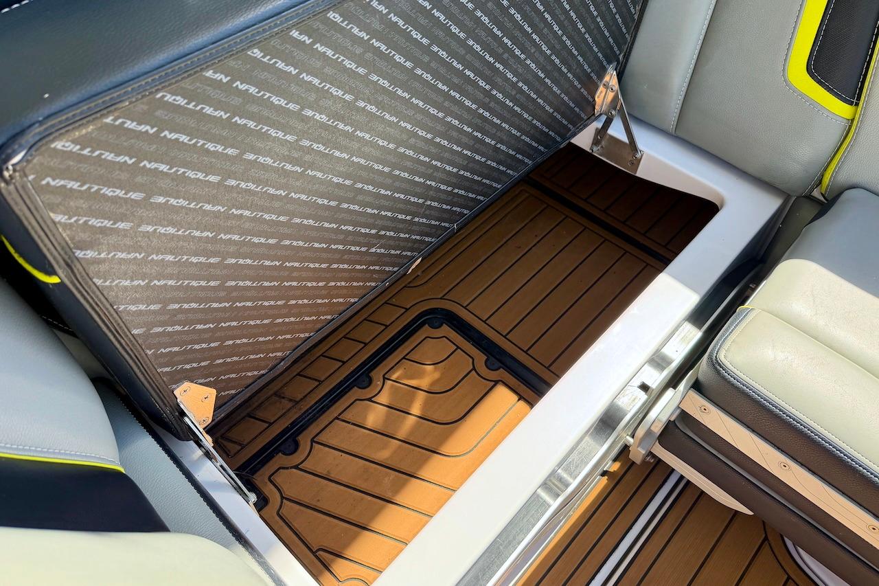 2014 Nautique Super Air Nautique G21 interior storage compartment with branded upholstery.