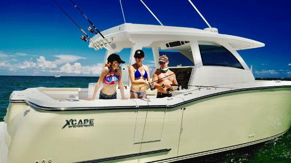 Three people enjoying fishing on a 2019 Altima 38 Xcape boat.