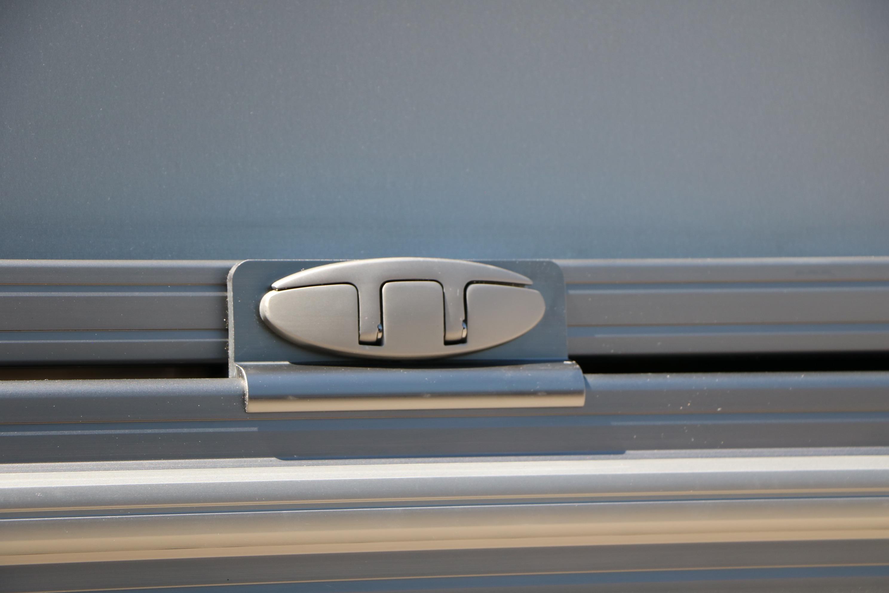 Close-up of 2026 Evotti 725 CS Tri-Toon latch detail on sleek metallic surface.