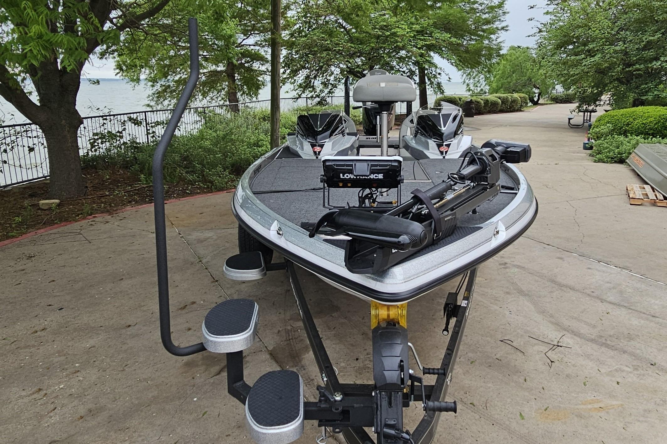 2026 Ranger Z521R Cup-Equipped boat on trailer, parked near a lakeside path.
