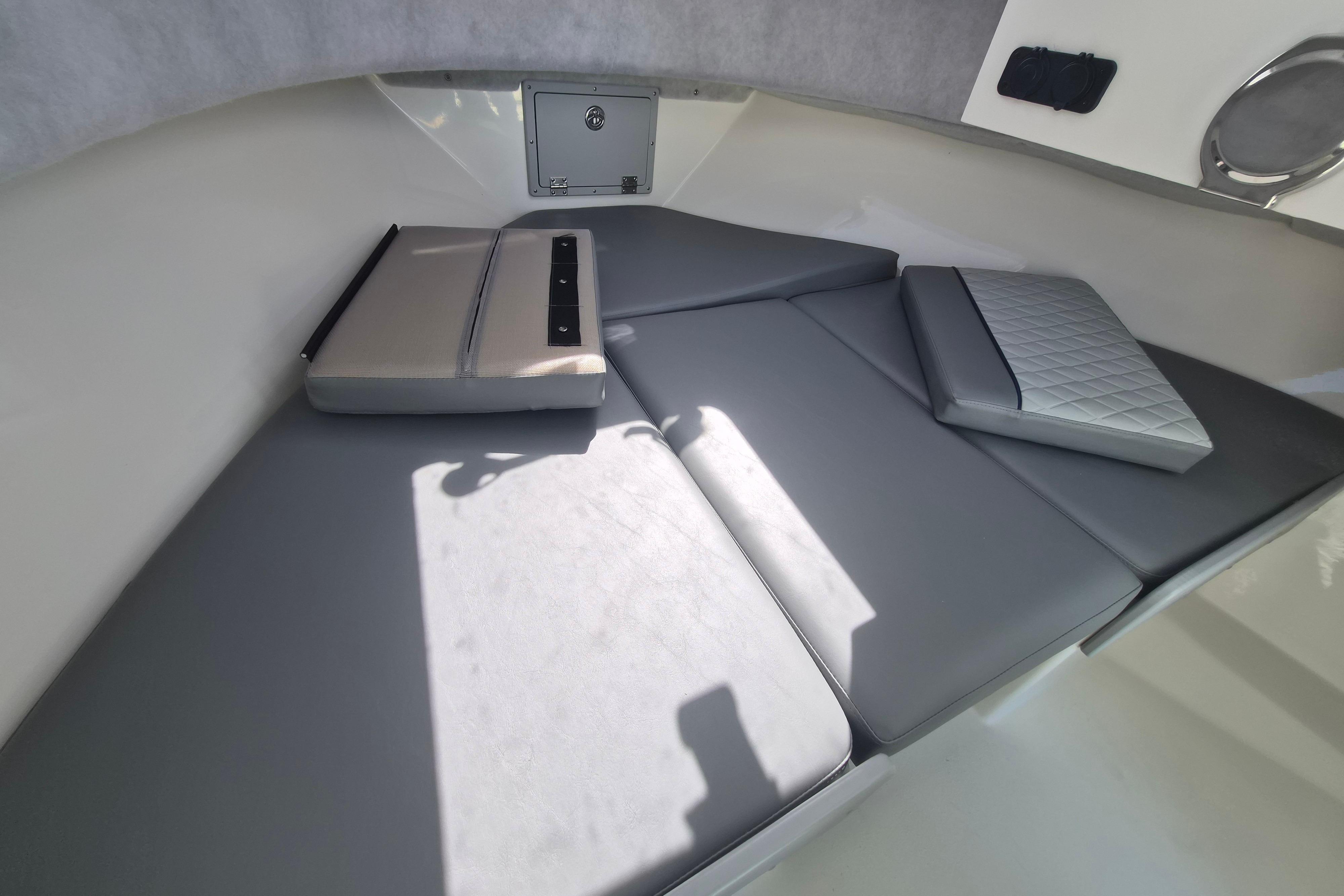 Interior of Defiance Admiral 220 EX 2026 with gray cushions.