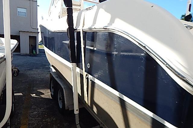 2003 World Cat 270 EC boat on trailer, blue and white exterior, parked outdoors.
