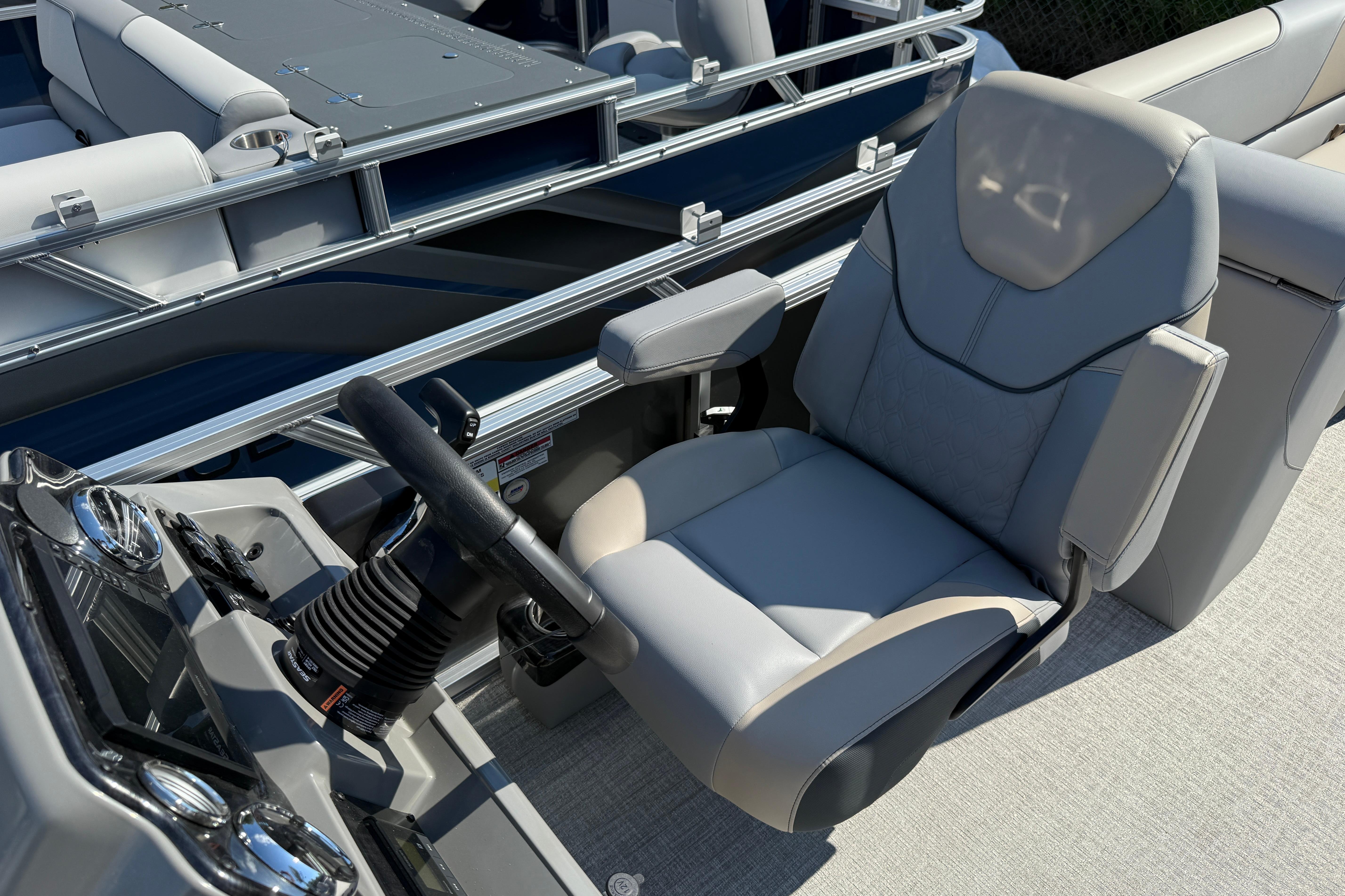 2026 Tahoe Pontoon Sport 85 Quad Lounger captain's chair and helm, showcasing luxury design.