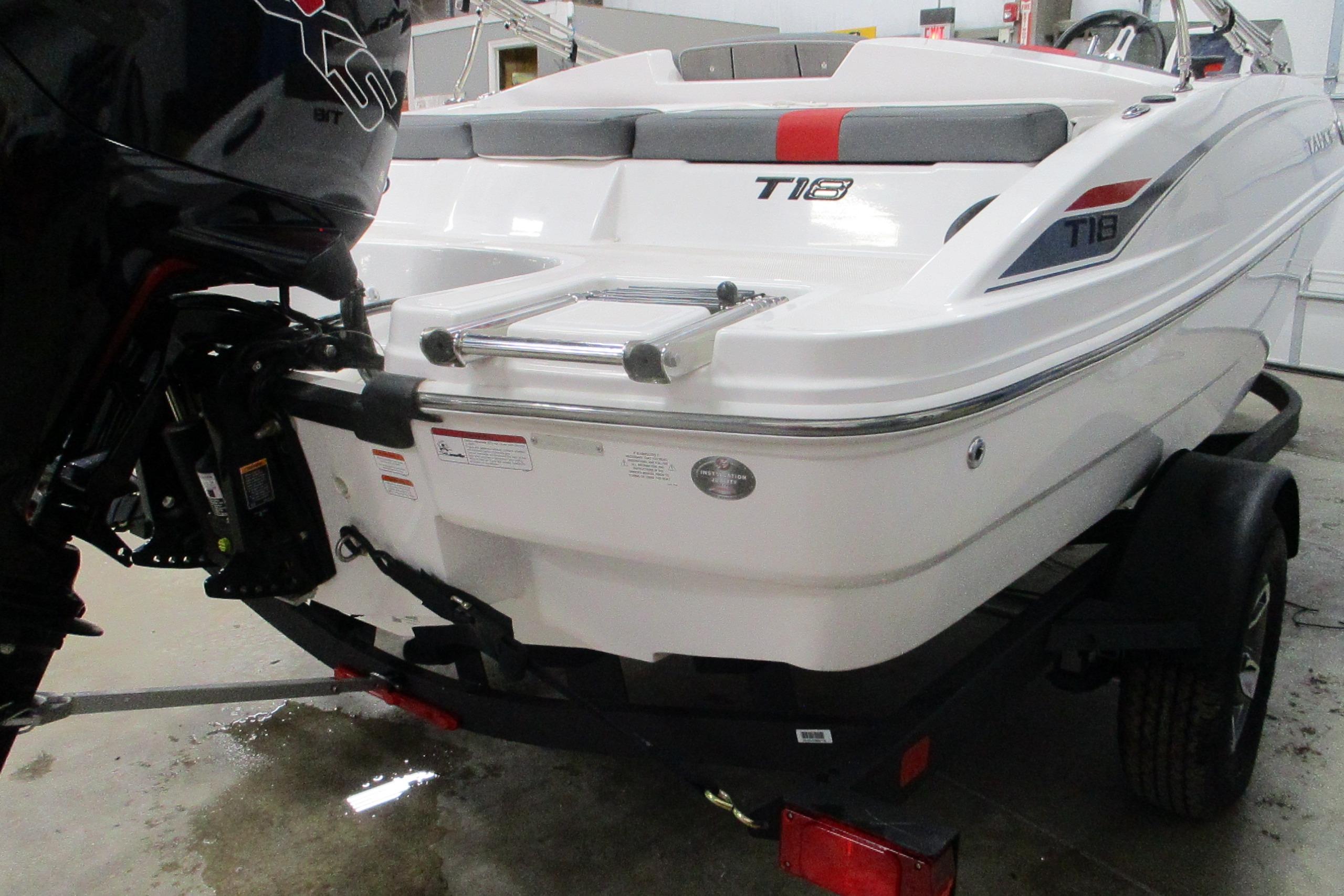 2025 Tahoe T18 boat on trailer, rear view with motor and ladder.