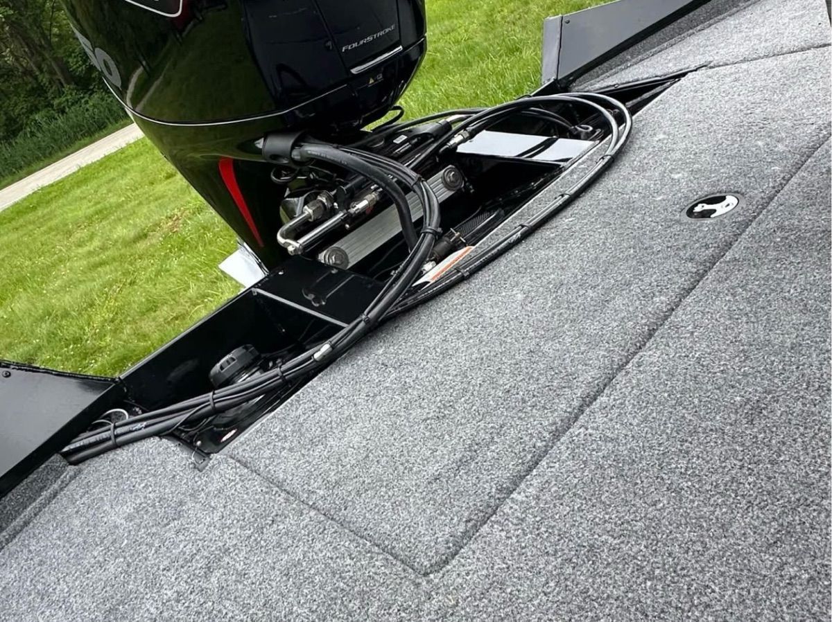 The image shows the rear of a 2022 Bass Tracker 195TXW boat with an outboard motor.