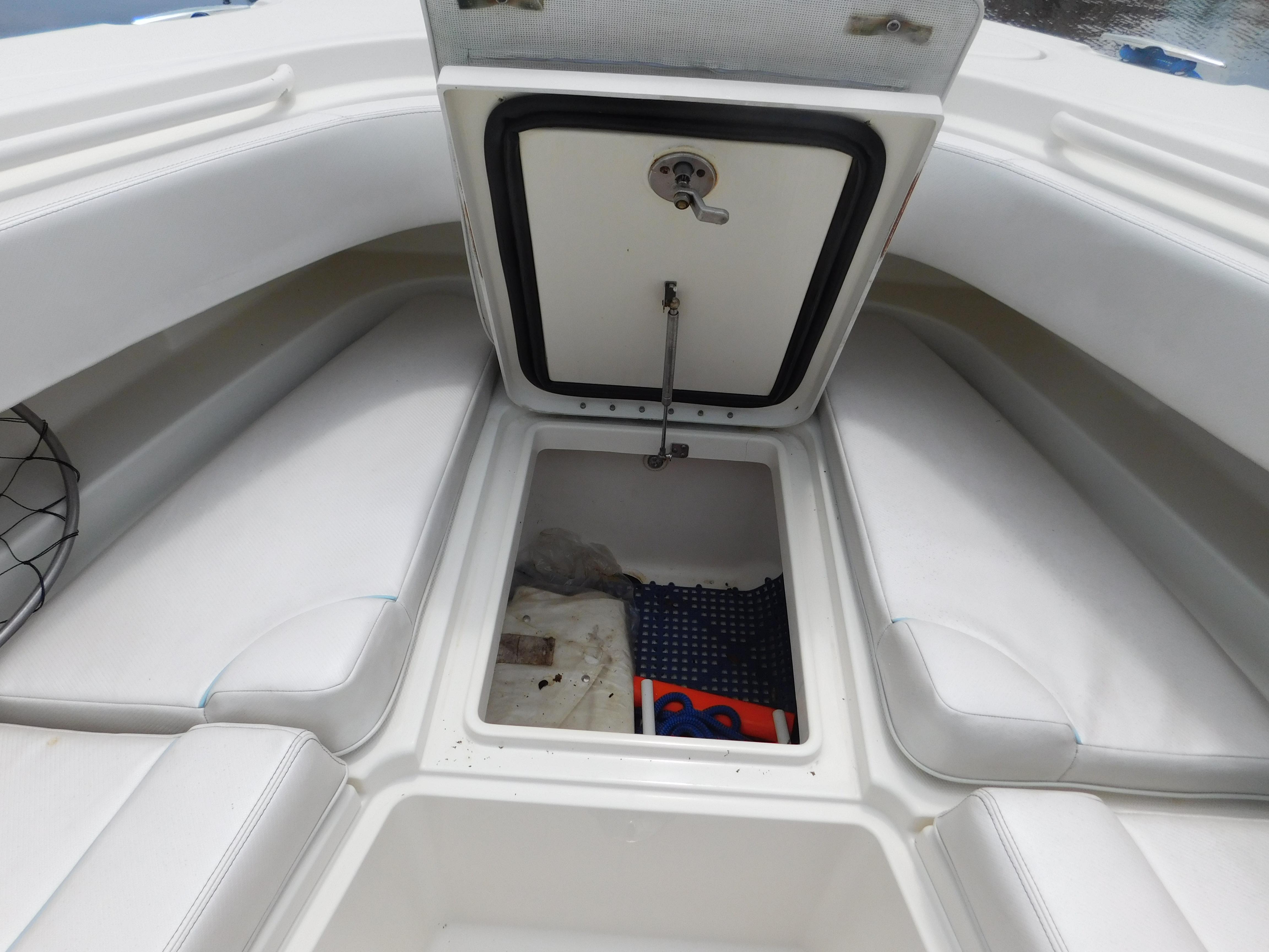 2013 Hydra-Sports 4200 Siesta boat storage compartment with open hatch and seating area.