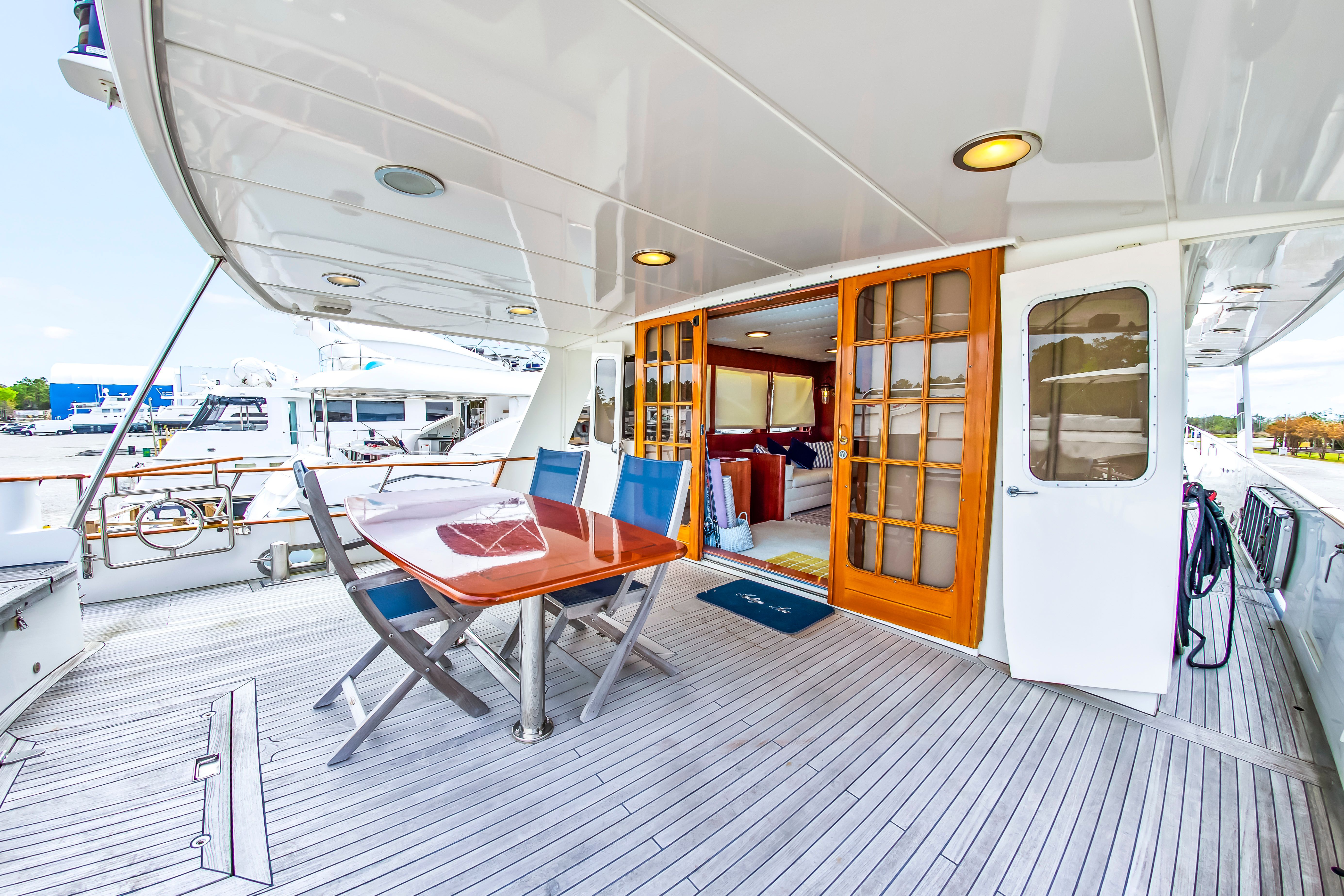 Deck area of the 1987 Jongert 78 Motor Yacht with dining table and chairs.