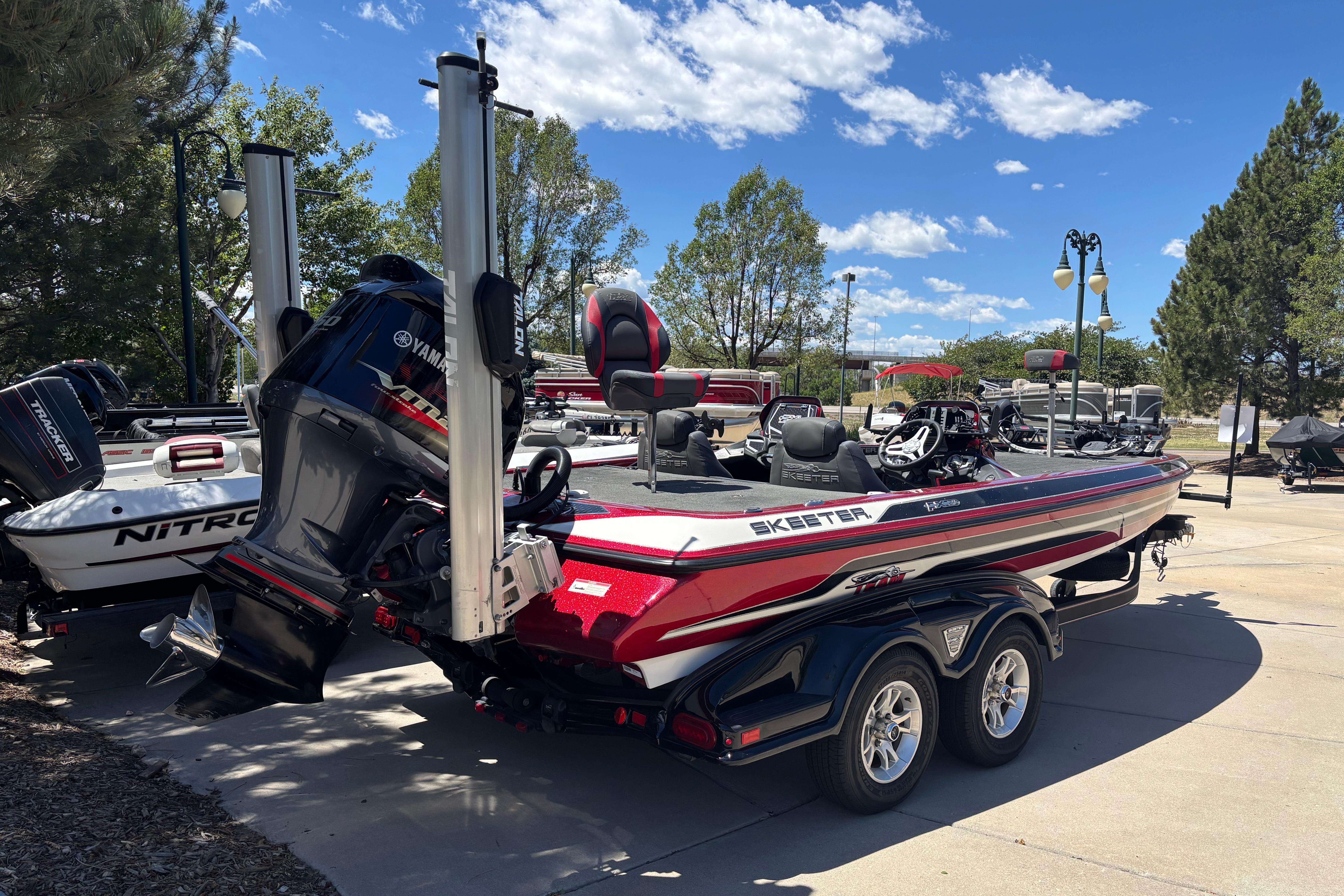 2017 Skeeter FX21 boat with Yamaha engine on a trailer, parked outdoors.