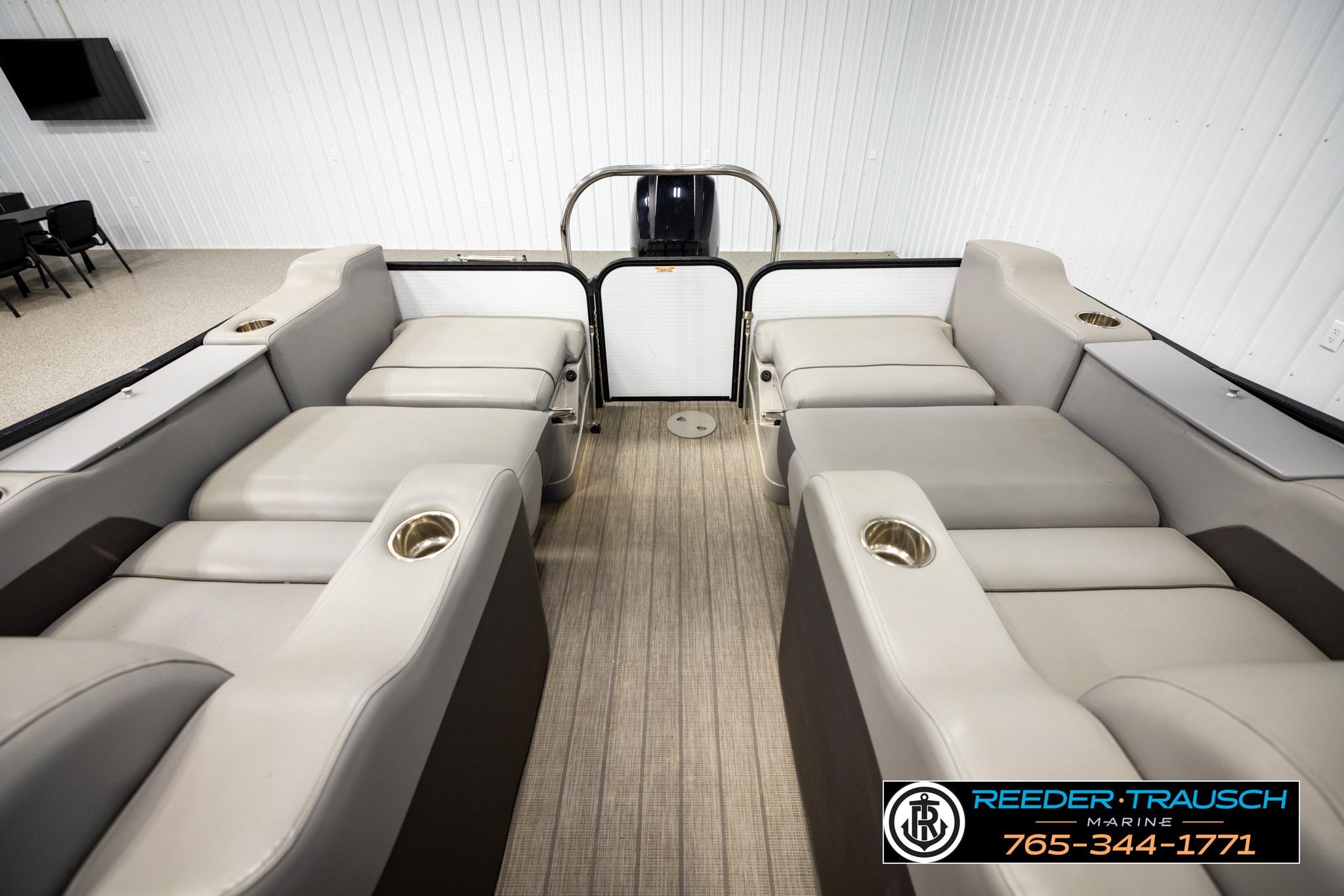 2019 Manitou Oasis SR VP pontoon boat interior with plush seating and cup holders.