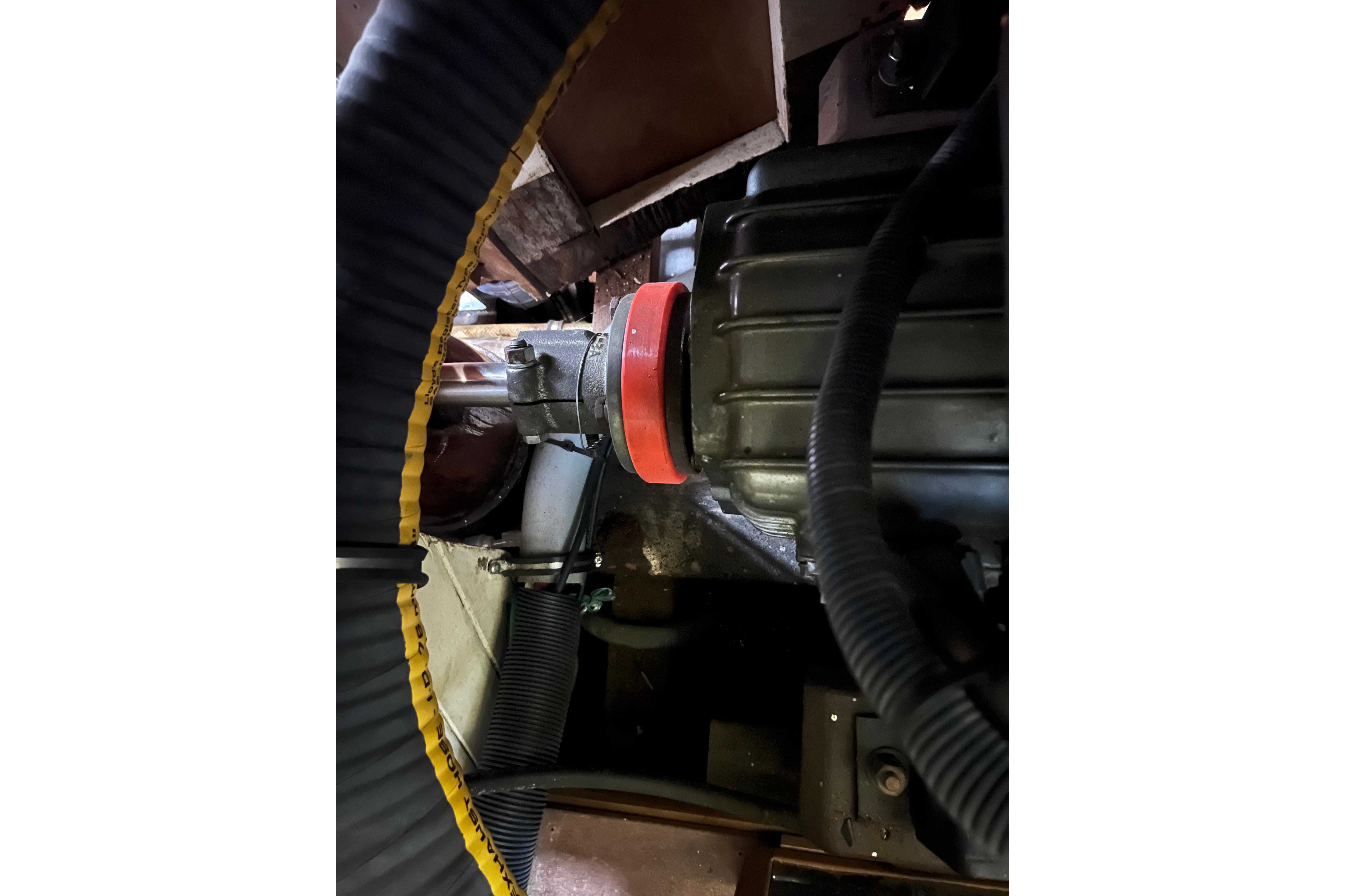 Engine compartment of 1947 Murray Peterson Schooner, featuring hoses and mechanical components.