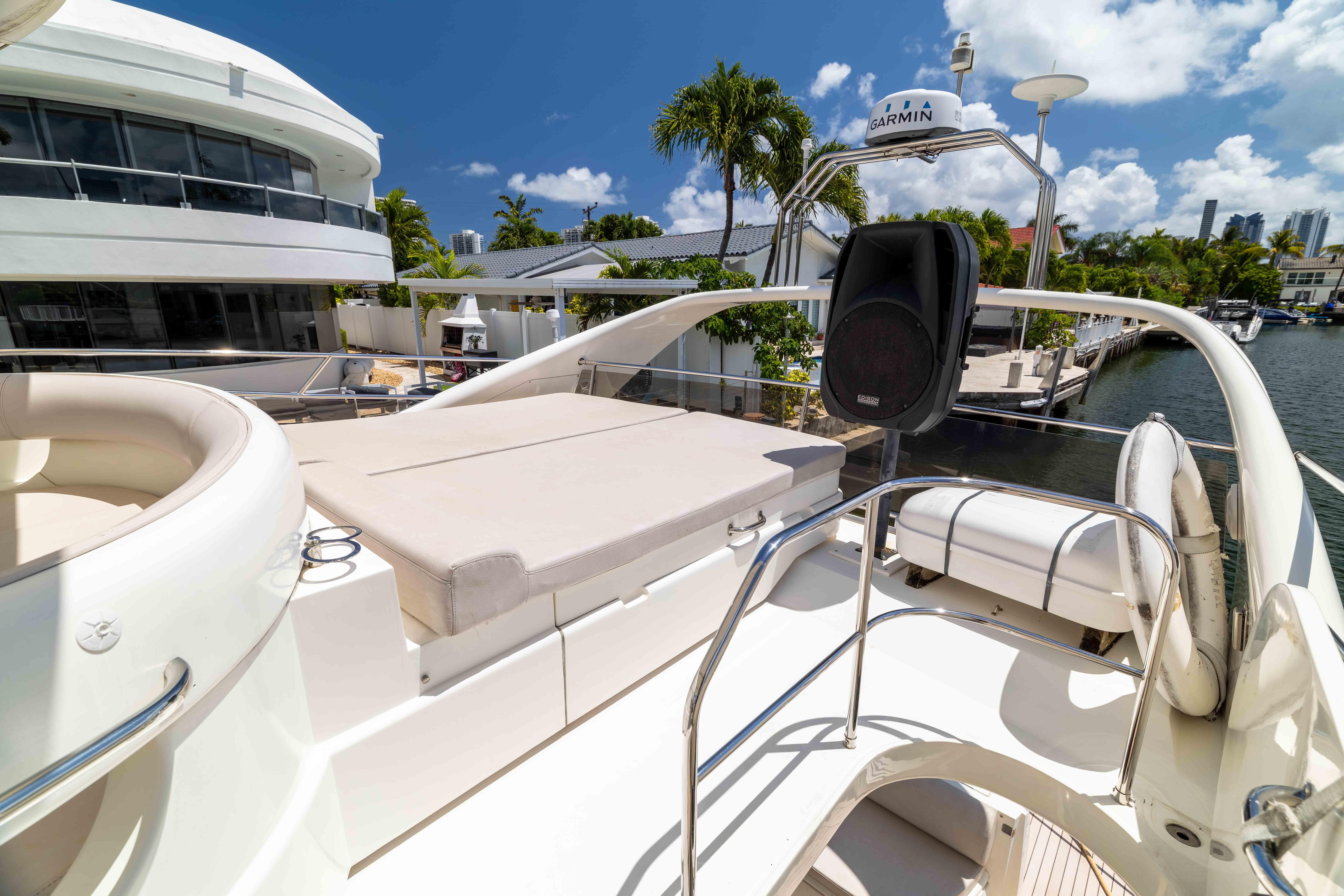 Luxurious 2002 Princess 61 yacht deck with seating, speaker, and waterway view.