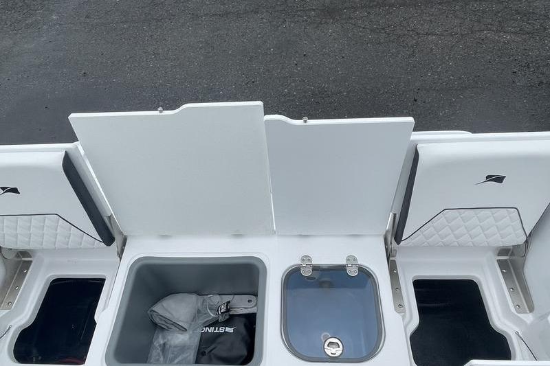 2025 Stingray 173CC boat storage compartments with open lids, showcasing interior features.