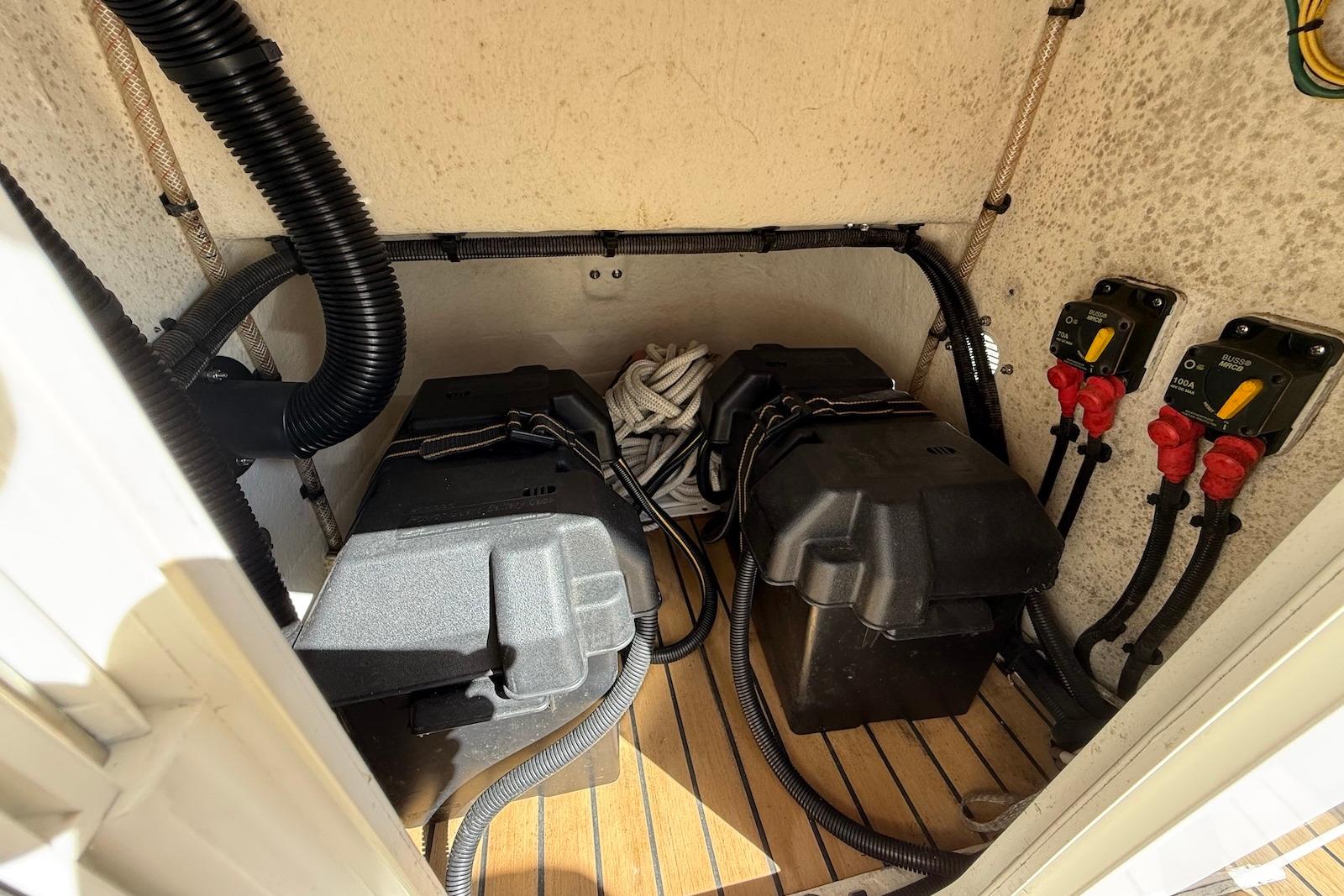 Battery compartment of a 2018 Ribcraft 7.8 boat with wiring and switches.