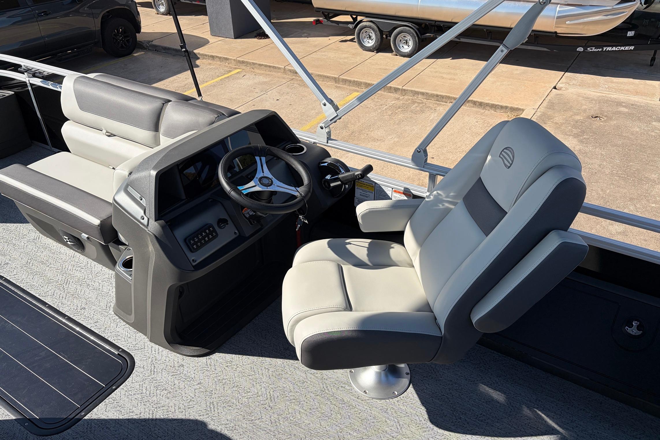 2026 Sun Tracker Fishin' Barge 22 XP3 interior with steering console and seating.